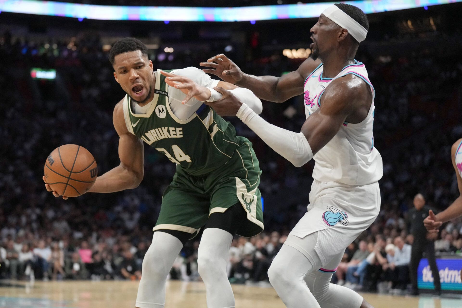 Milwaukee Bucks forward Giannis Antetokounmpo (34) looks for space as Miami Heat center Bam Adebayo (13) defends during the second half at Kaseya Center.