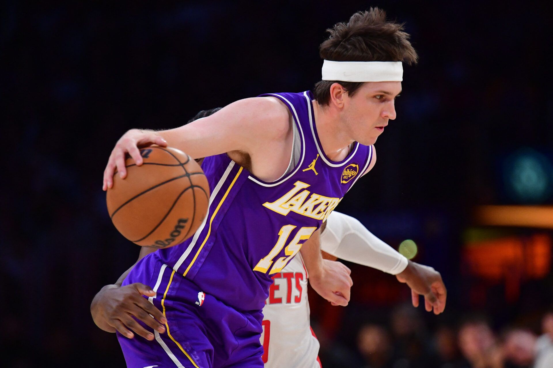 Los Angeles Lakers guard Austin Reaves (15) moves the ball against Houston Rockets guard Aaron Holiday (0) during the first half in game five of the first round of the 2026 NBA Playoffs at Crypto.com Arena.