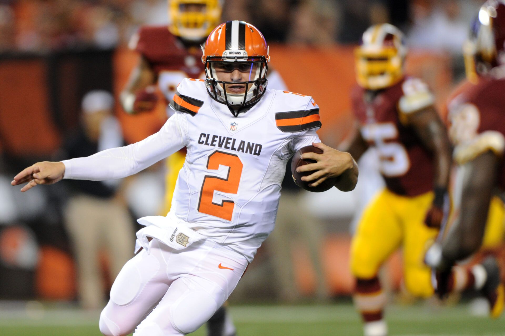 Cleveland Browns quarterback Johnny Manziel (2) runs for a touchdown during the second quarter against the Washington Commanders in a preseason NFL football game at FirstEnergy Stadium.
