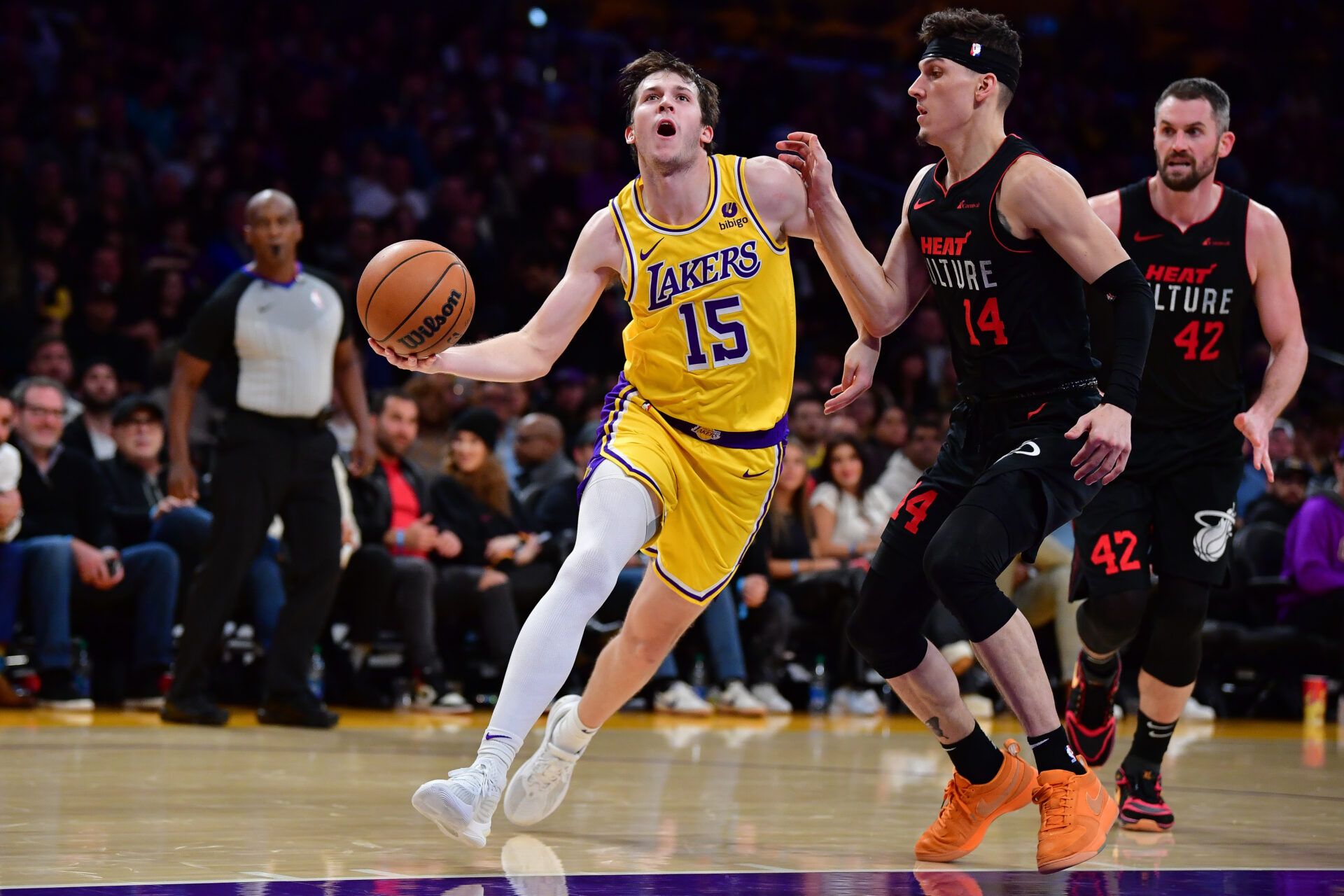 Los Angeles Lakers guard Austin Reaves (15) moves the ball against Miami Heat guard Tyler Herro (14) during the second half at Crypto.com Arena.
