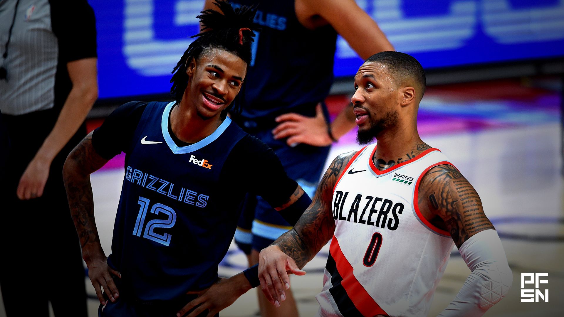Memphis Grizzlies guard Ja Morant (12) and Portland Trail Blazers guard Damian Lillard (0) share a moment during the second half of the game at Moda Center. The Grizzlies won 120-113.