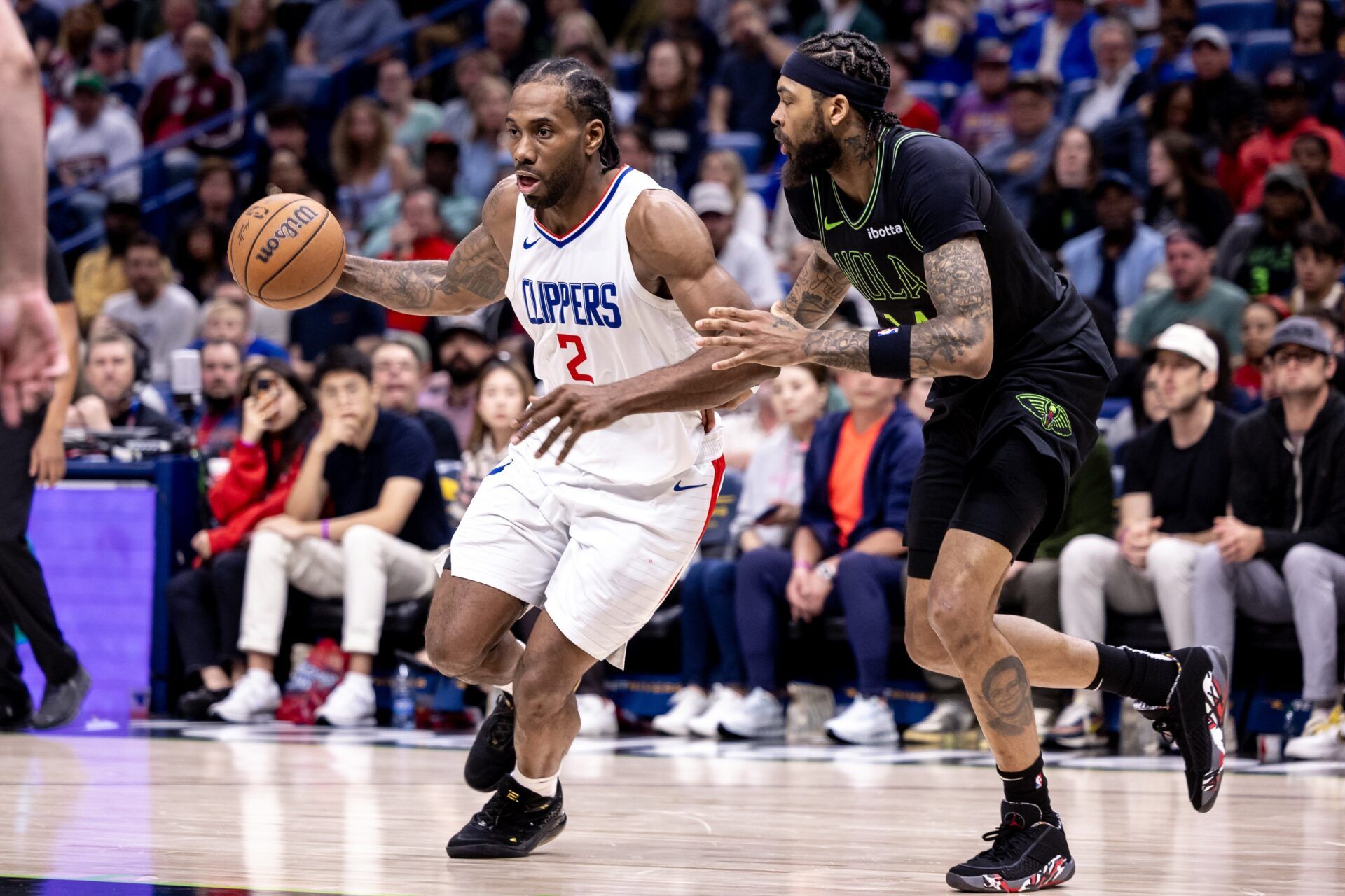 LA Clippers forward Kawhi Leonard (2) dribbles against New Orleans Pelicans forward Brandon Ingram (14) during the second half at Smoothie King Center.
