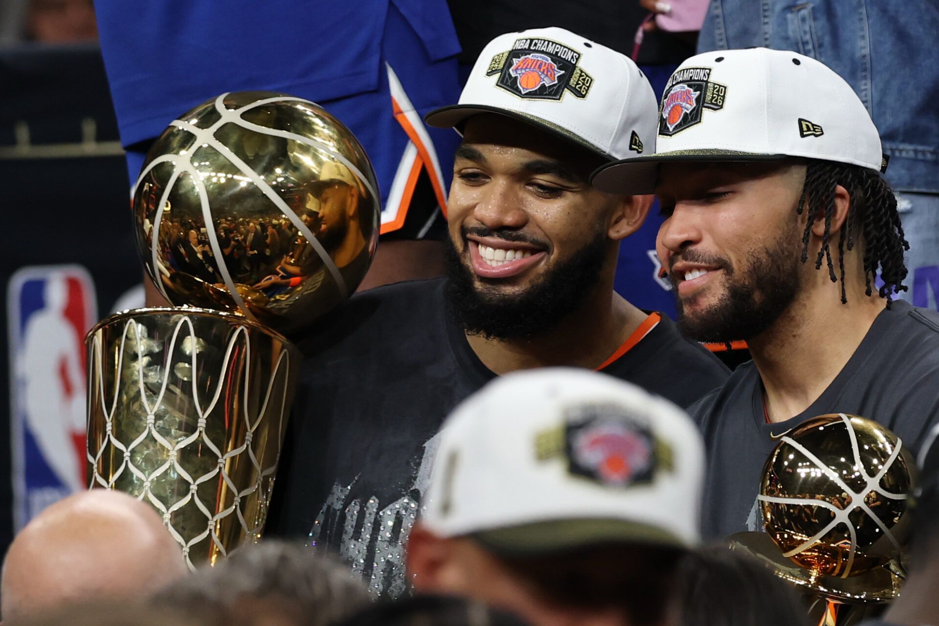 New York Knicks center Karl-Anthony Towns (L) holds the Larry O'Brien championship trophy as Knicks guard Jalen Brunson (R) holds the Finals MVP trophy after game five of the 2026 NBA Finals against the San Antonio Spurs at Frost Bank Center.