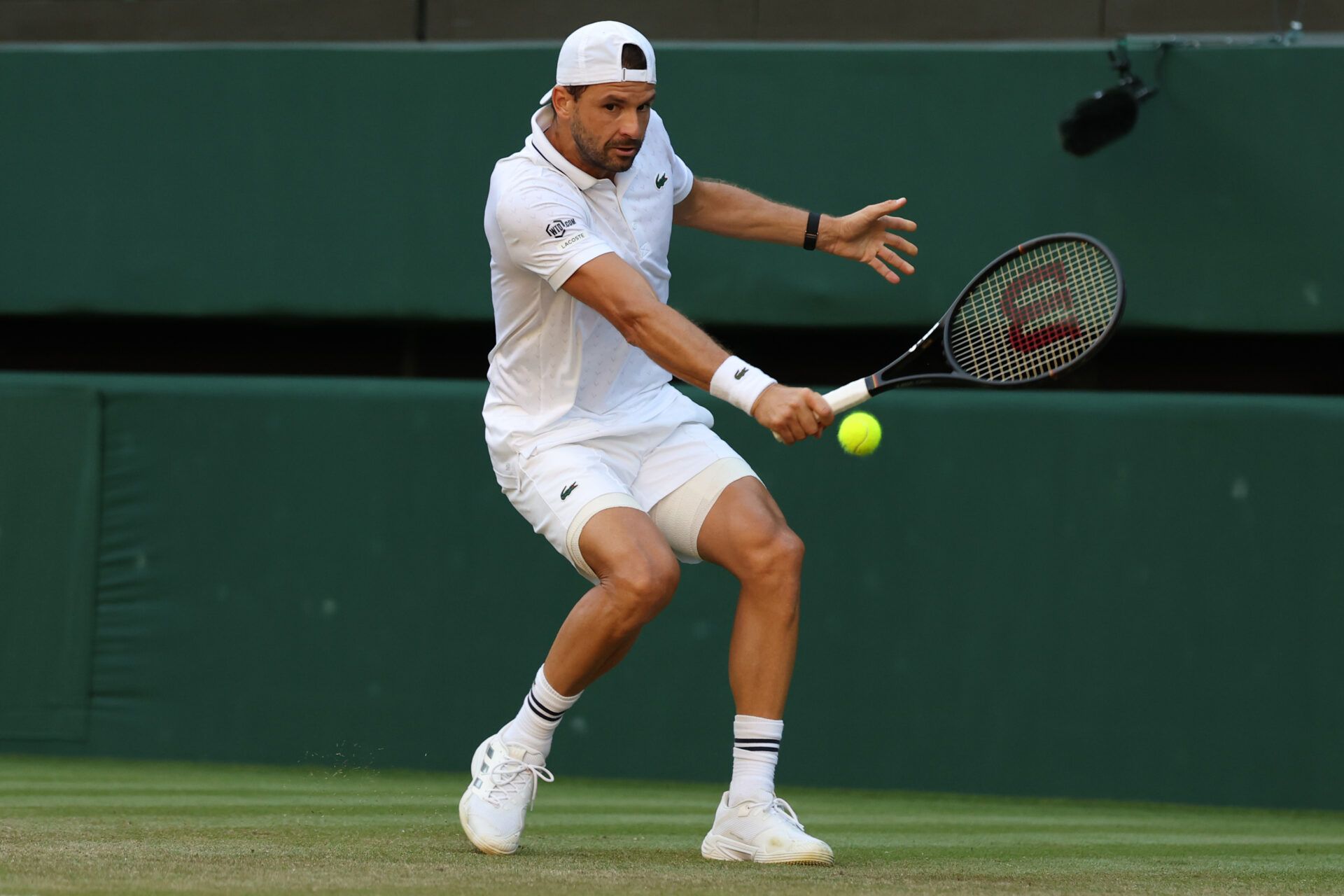 Grigor Dimitrov (BUL) hits a backhand against Jakub Mensik (CZE) (not pictured) on day four of The Championships Wimbledon 2026 at All England Lawn Tennis and Croquet Club.