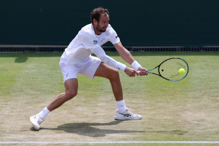 Roman Safiullin hits a backhand against João Fonseca (BRA) (not pictured) on day five of The Championships Wimbledon 2026 at All England Lawn Tennis and Croquet Club.