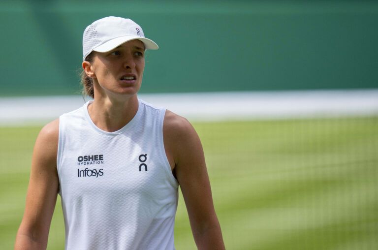 Iga Swiatek of Poland reacts during her match against Taylor Townsend of the United States on day two at All England Lawn Tennis and Croquet Club.