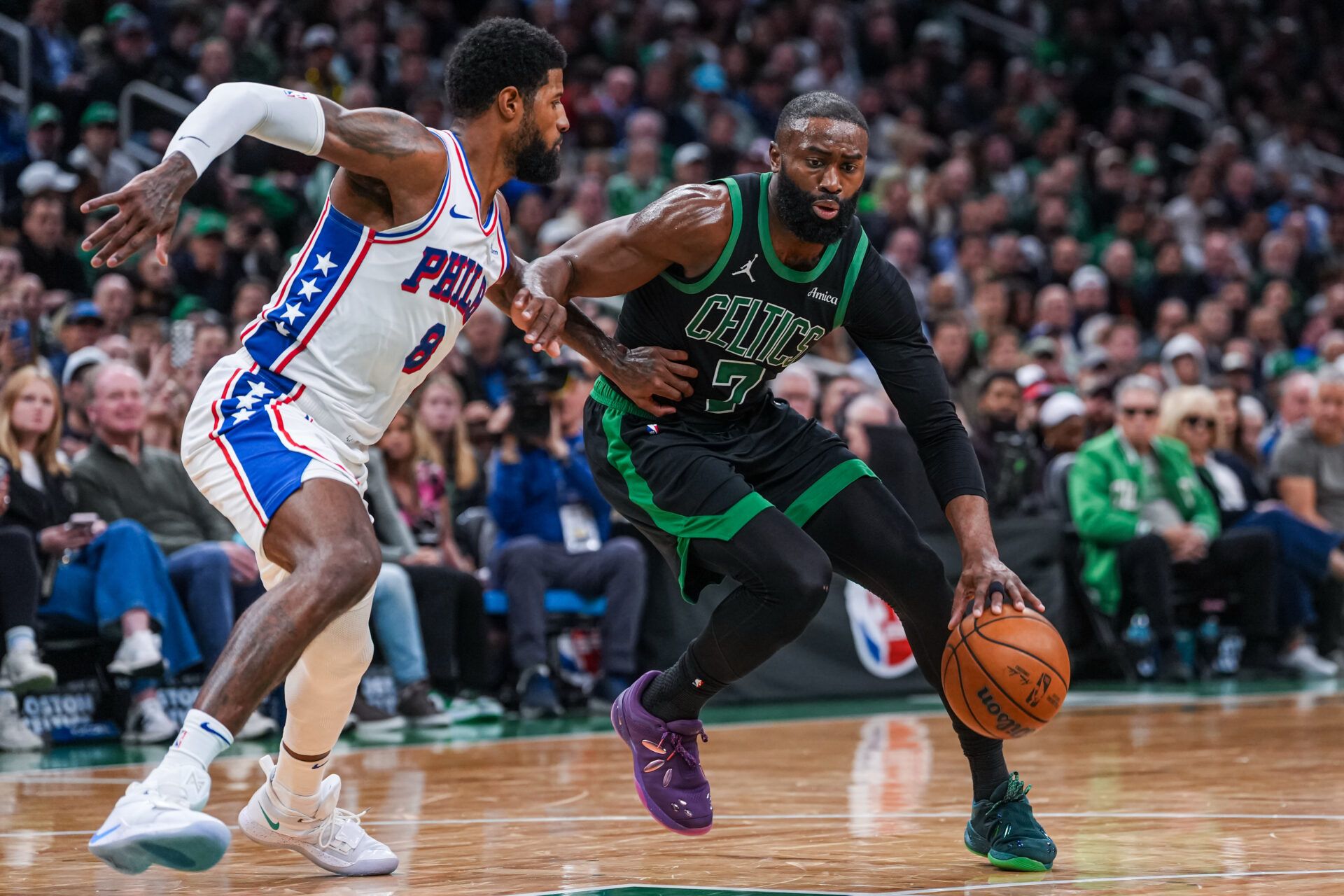 Boston Celtics guard Jaylen Brown (7) drives the ball against Philadelphia 76ers forward Paul George (8) in the second half during game five of the first round of the 2026 NBA Playoffs at TD Garden.