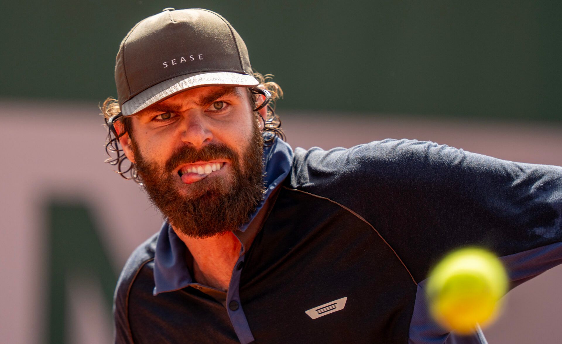 Reilly Opelka of the United States returns a shot in his first round match against Federico Cinta of Italy on day one at Stade Roland Garros.