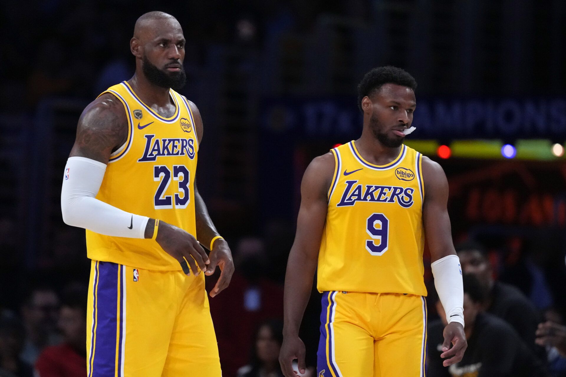 Los Angeles Lakers forward LeBron James (23) and son Bronny James (9) react in the first half against the Houston Rockets during game one of the first round of the 2026 NBA Playoffs at Crypto.com Arena.