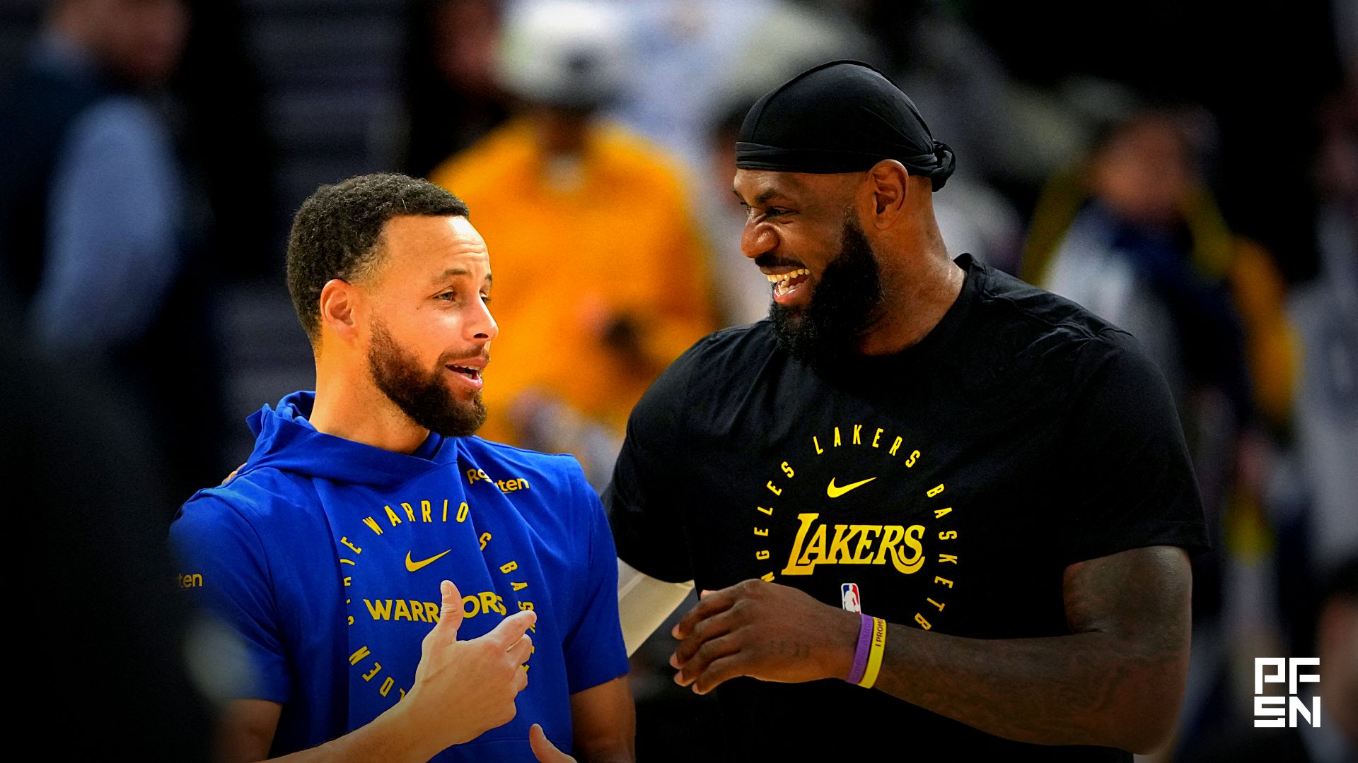 Golden State Warriors guard Stephen Curry (left) and Los Angeles Lakers forward LeBron James (right) talk before the game at Chase Center.