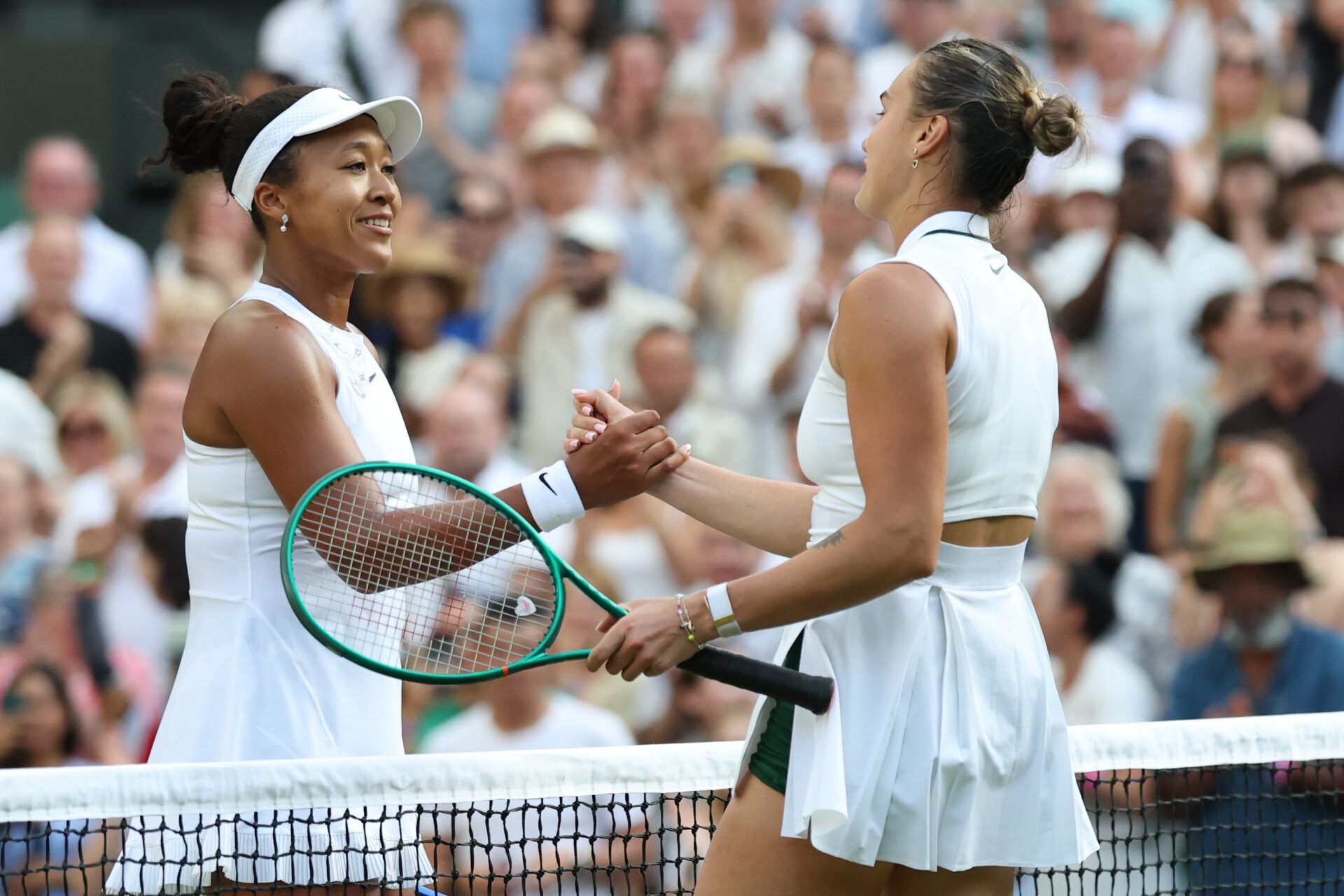 Naomi Osaka (JPN) (L) shakes hands with Aryna Sabalenka (R) at the net after their match on day seven of The Championships Wimbledon 2026 at All England Lawn Tennis and Croquet Club.