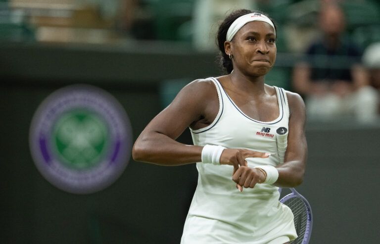 Coco Gauff of the United States points to the time as she celebrates winning her match against Belinda Bencic of Switzerland on day seven at All England Lawn Tennis and Croquet Club.
