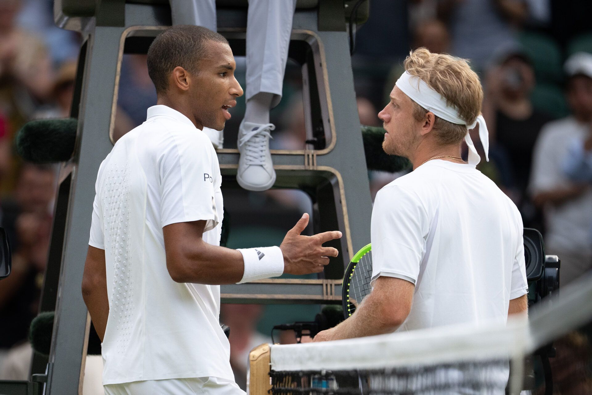 Felix Auger-Aliassime of Canada and Alejandro Davidovich Fokina of Spain exchange words after their match on day seven at All England Lawn Tennis and Croquet Club.