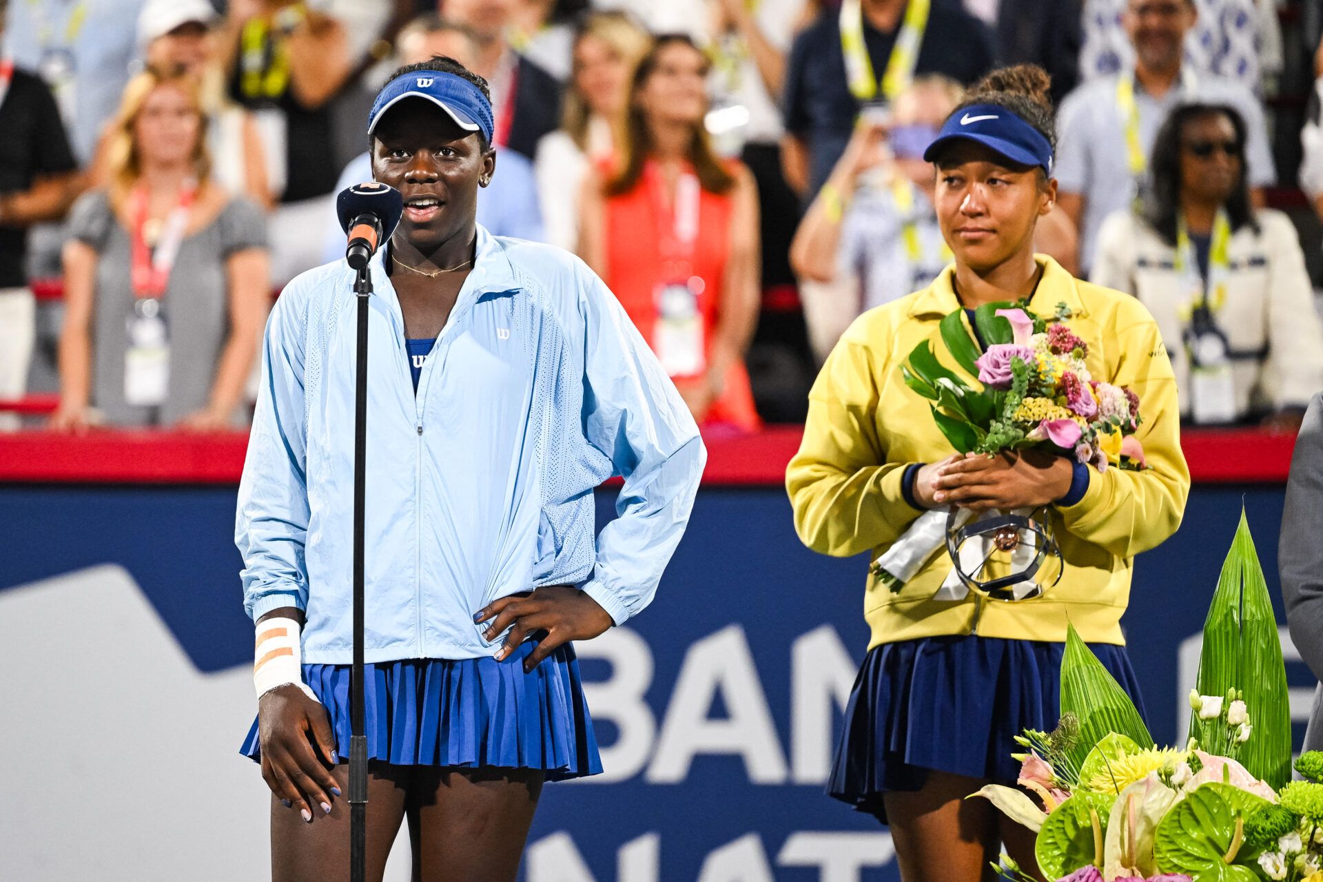 Victoria Mboko (CAN) tournament winner addresses the crowd beside runner up Naomi Osaka (JPN) at IGA Stadium.