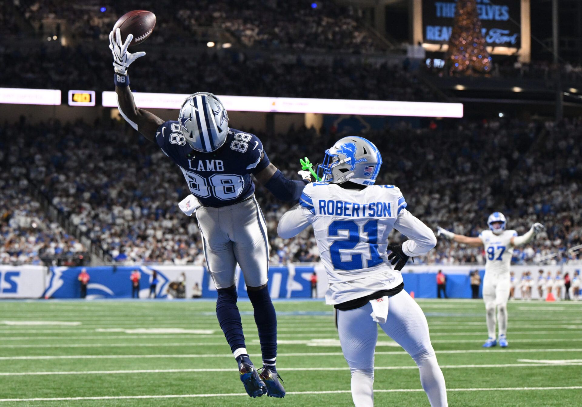 Dallas Cowboys wide receiver CeeDee Lamb (88) attempts to make a catch against Detroit Lions cornerback Amik Robertson (21) during the second half at Ford Field.