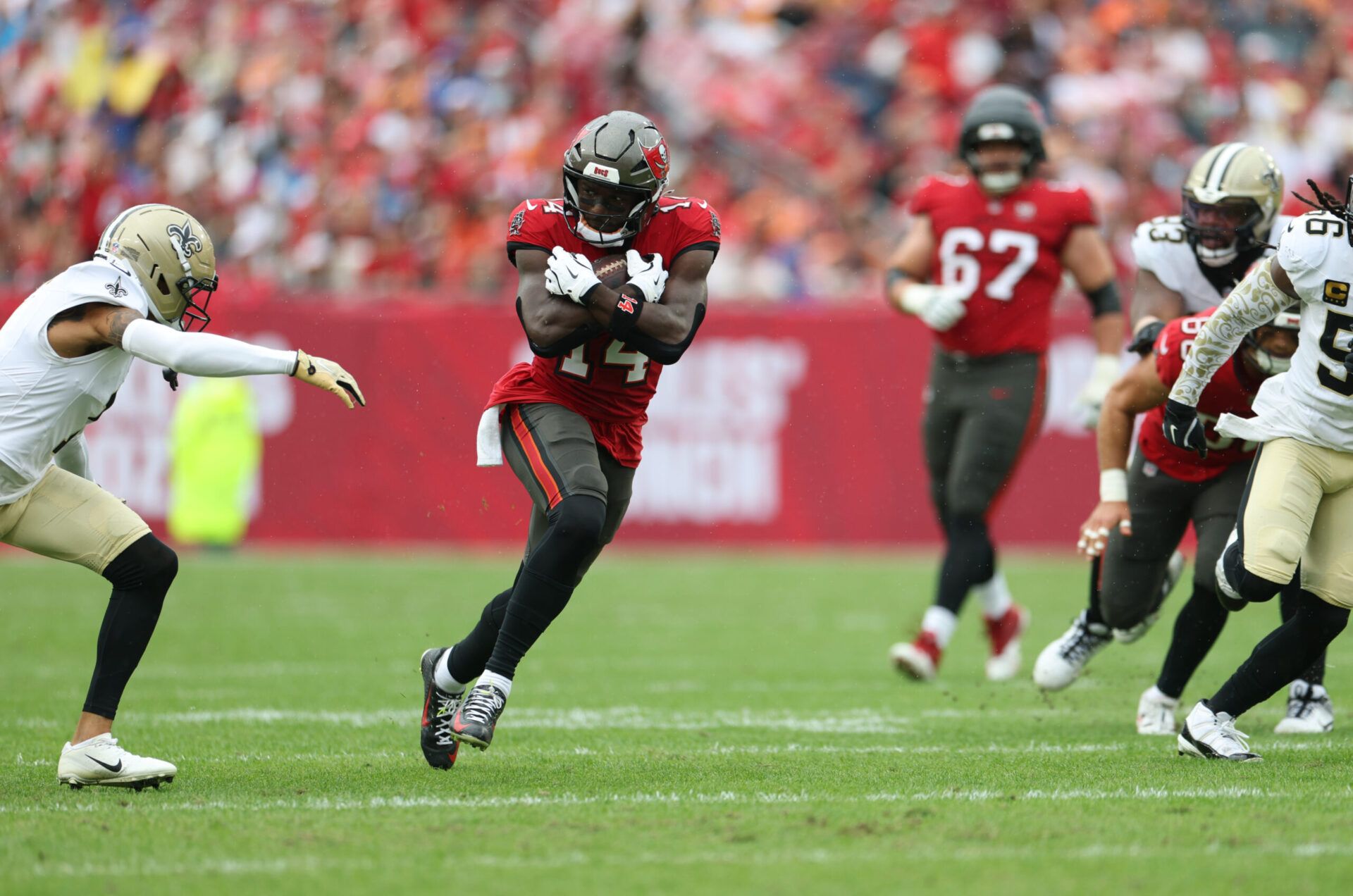 Tampa Bay Buccaneers wide receiver Chris Godwin Jr. (14) runs for a gain during the first quarter against the New Orleans Saints at Raymond James Stadium.