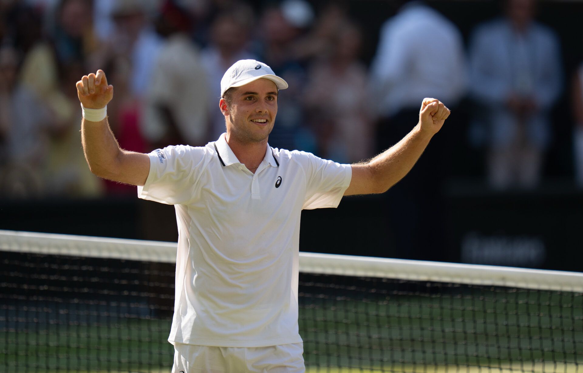 Arthur Fery of Great Britain celebrates winning his match against Flavio Cobolli of Italy at the net after their match on day 10 at All England Lawn Tennis and Croquet Club.