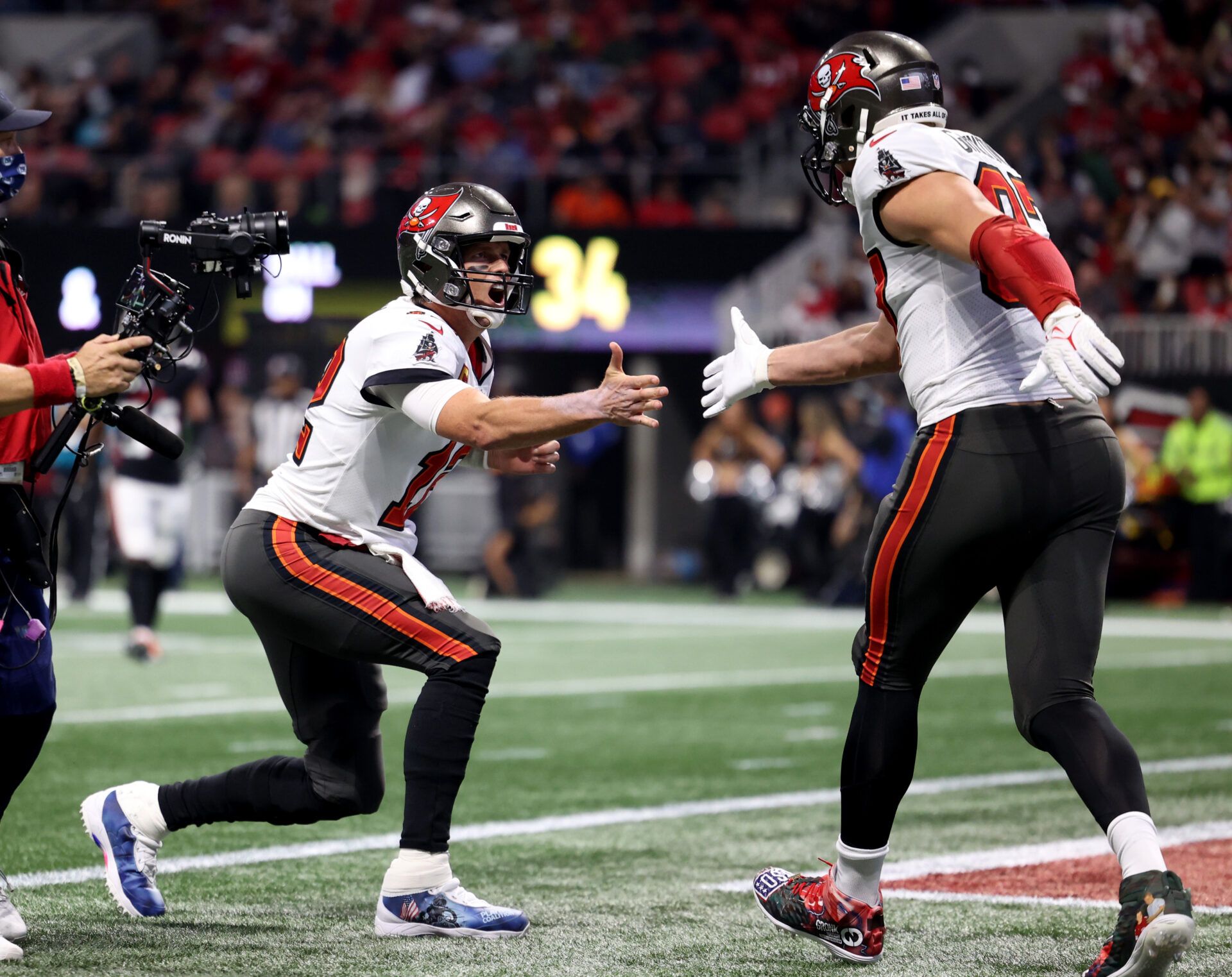 Tampa Bay Buccaneers tight end Rob Gronkowski (87) celebrates his touchdown with quarterback Tom Brady (12) during the second quarter against the Atlanta Falcons at Mercedes-Benz Stadium.