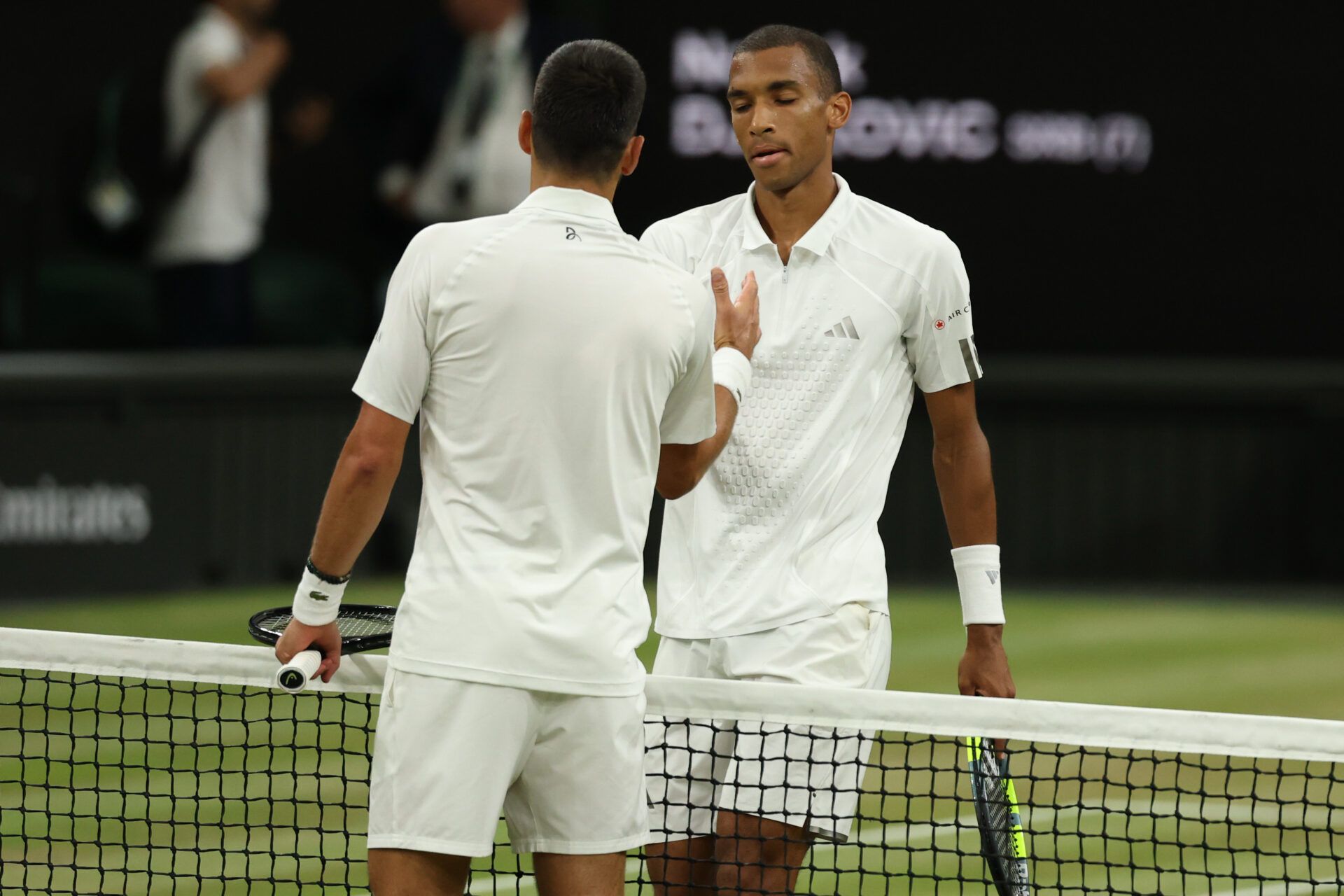 Novak Djokovic (SRB) (L) shakes hands with Felix Auger-Aliassime (CAN) (R) at the net after their match on day nine of The Championships Wimbledon 2026 at All England Lawn Tennis and Croquet Club.