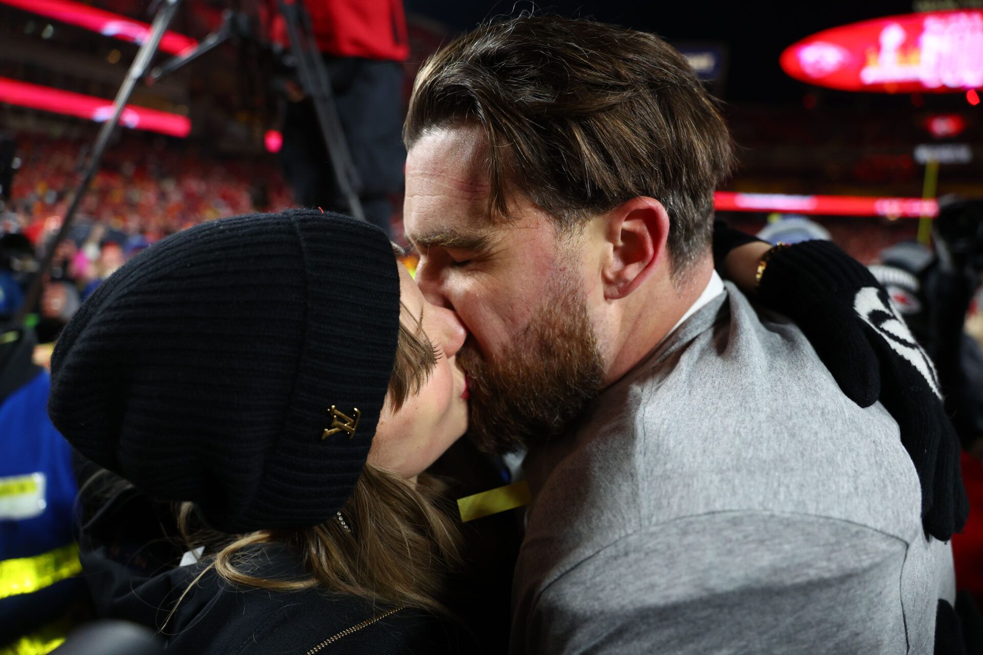 Recording artist Taylor Swift  and Kansas City Chiefs tight end Travis Kelce (87) react after the AFC Championship game against the Buffalo Bills at GEHA Field at Arrowhead Stadium.