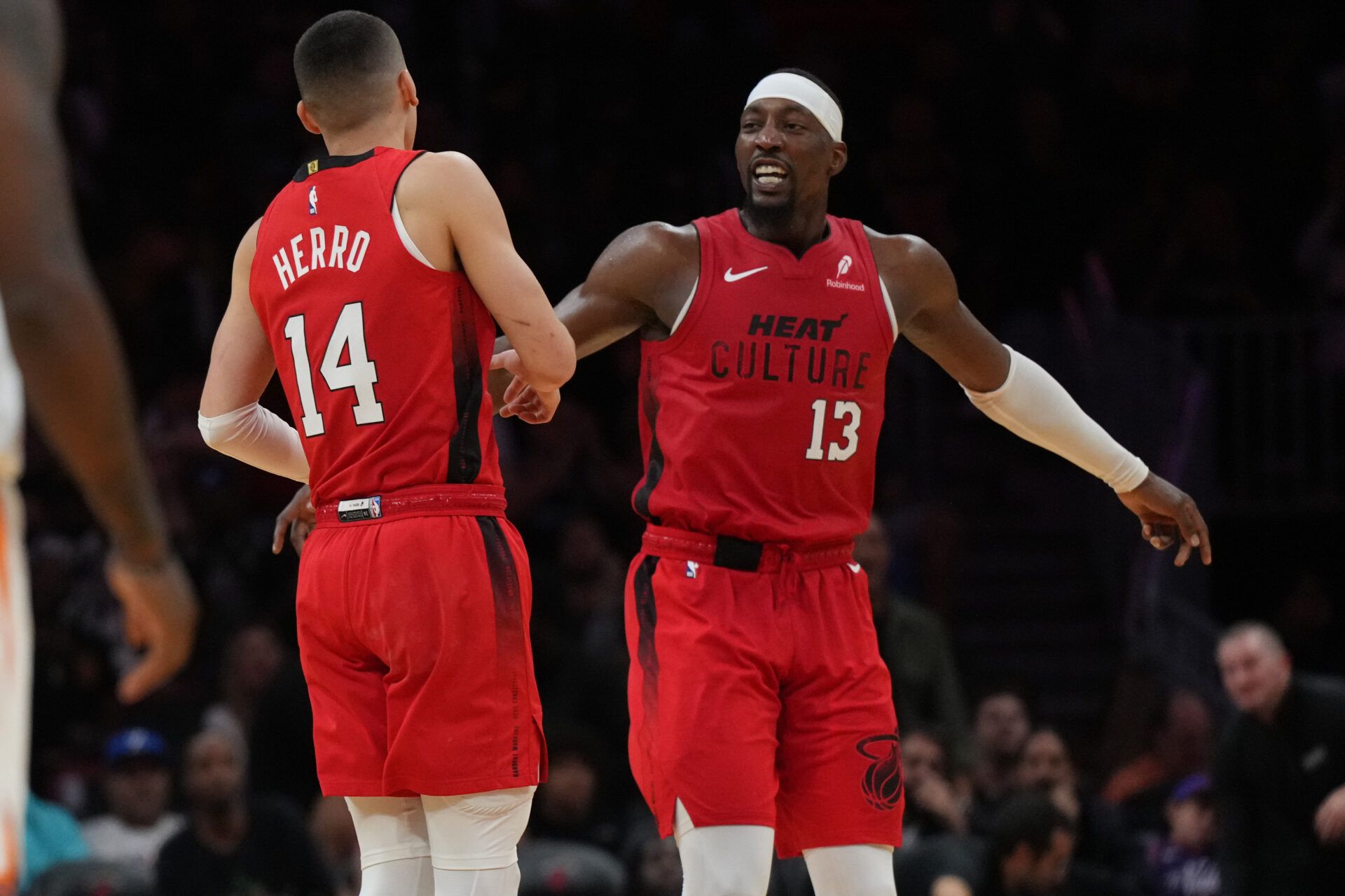 Miami Heat center Bam Adebayo (13) celebrates with guard Tyler Herro (14) after Herro made a three-point basket against the Phoenix Suns during the second half at Kaseya Center.