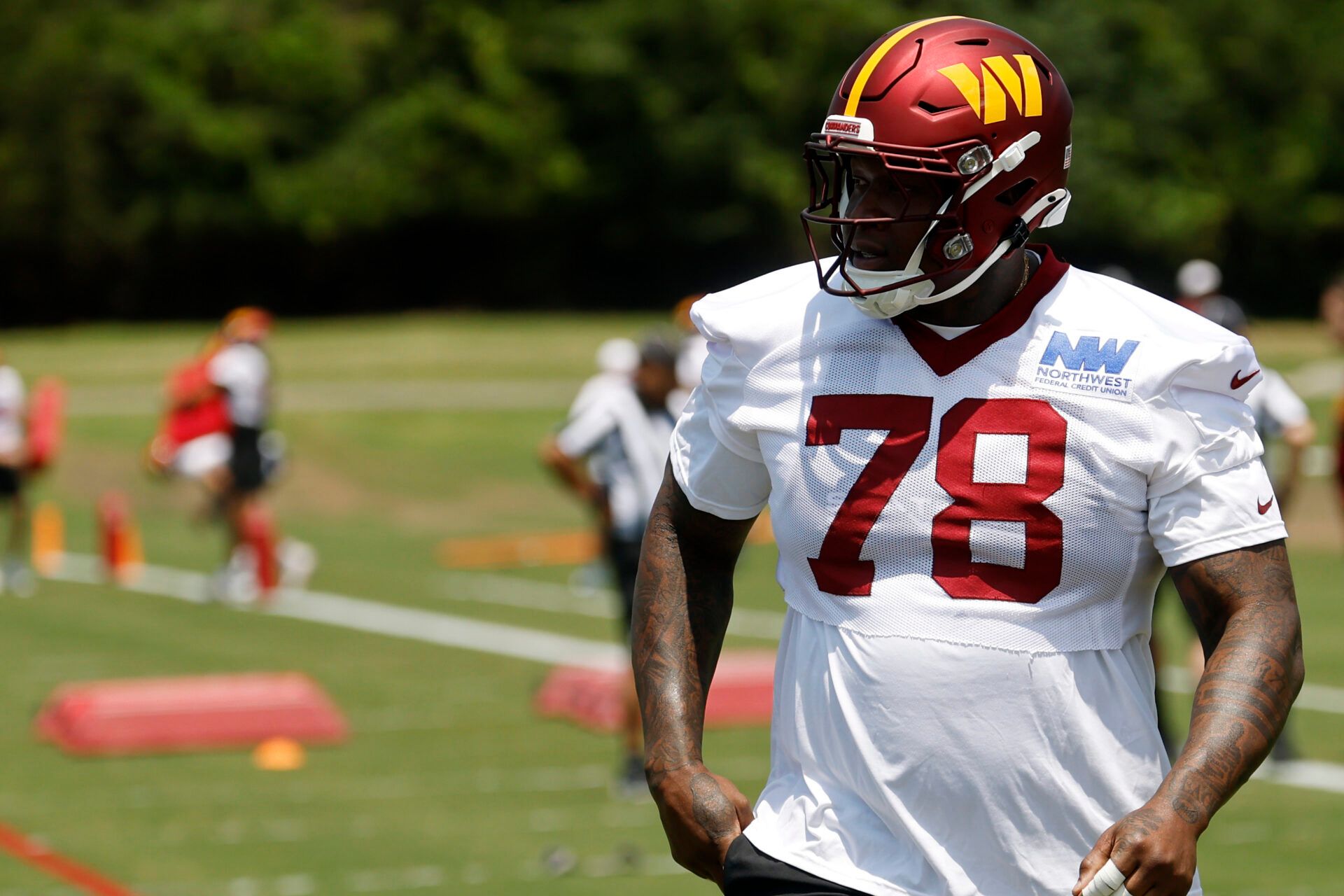 Washington Commanders offensive tackle Laremy Tunsil (78) stands on the field on day one of minicamp at Commanders Park.