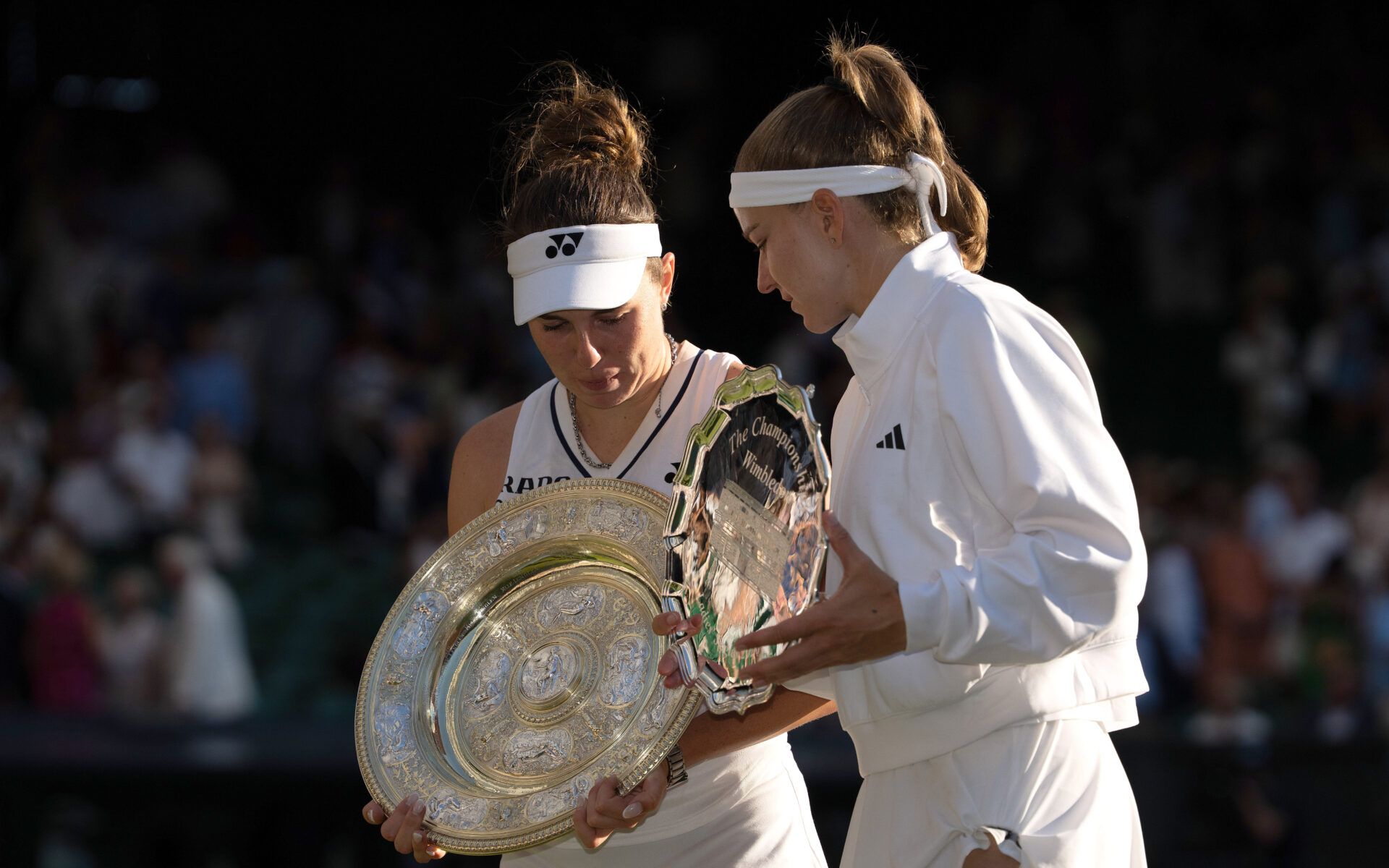 Linda Noskova of the Czech Republic and Karolina Muchova of the Czech Republic check out their trophies after the womens’ singles final on day 13 at All England Lawn Tennis and Croquet Club.