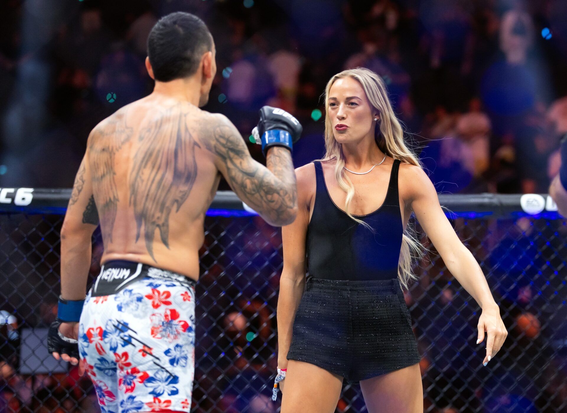 Indiana Fever guard Sophie Cunningham (right) jokes with Max Holloway following UFC 329 at T-Mobile Arena.