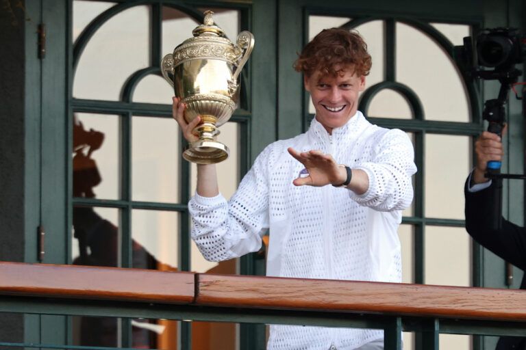 Jannik Sinner (ITA) holds the gentlemen's singles championship trophy on the South West Hall Balcony of Centre Court after the gentlemen's singles final of The Championships Wimbledon 2026 at All England Lawn Tennis and Croquet Club.
