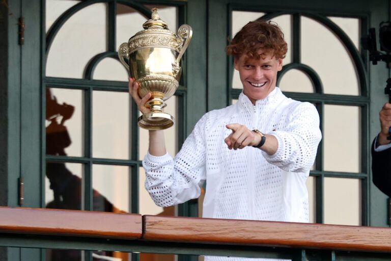 Jannik Sinner (ITA) holds the gentlemen's singles championship trophy on the South West Hall Balcony of Centre Court after the gentlemen's singles final of The Championships Wimbledon 2026 at All England Lawn Tennis and Croquet Club.