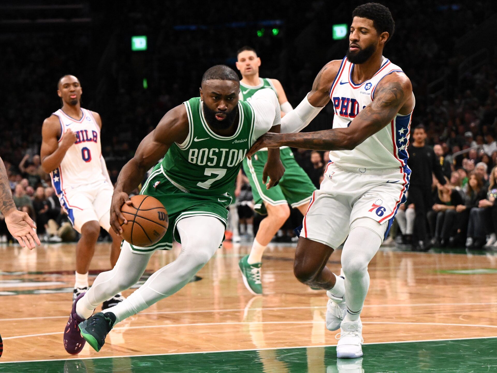 Boston Celtics guard Jaylen Brown (7) drives tot he basket against Philadelphia 76ers forward Paul George (8) in the second half of a game two of the first round of the 2026 NBA Playoffs at TD Garden.
