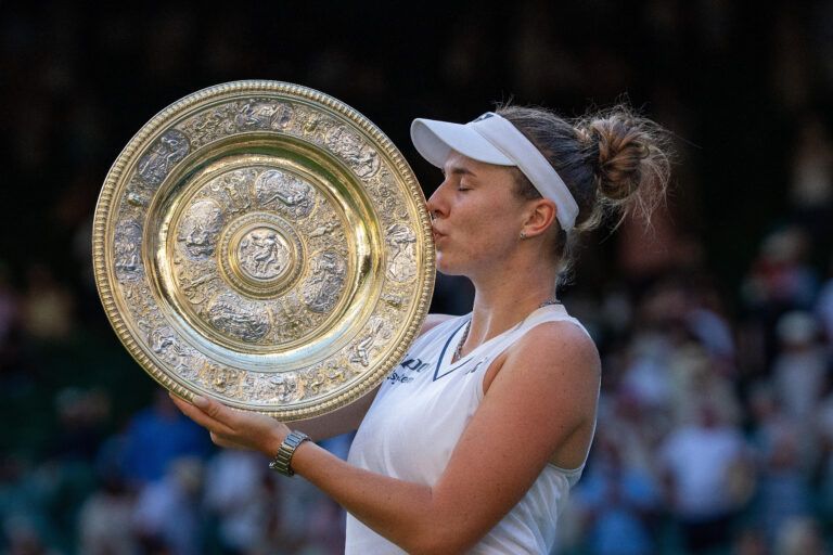 Linda Noskova of the Czech Republic kisses the trophy after winning the womens singles final against Karolina Muchova of the Czech Republic  on day 13 at All England Lawn Tennis and Croquet Club.