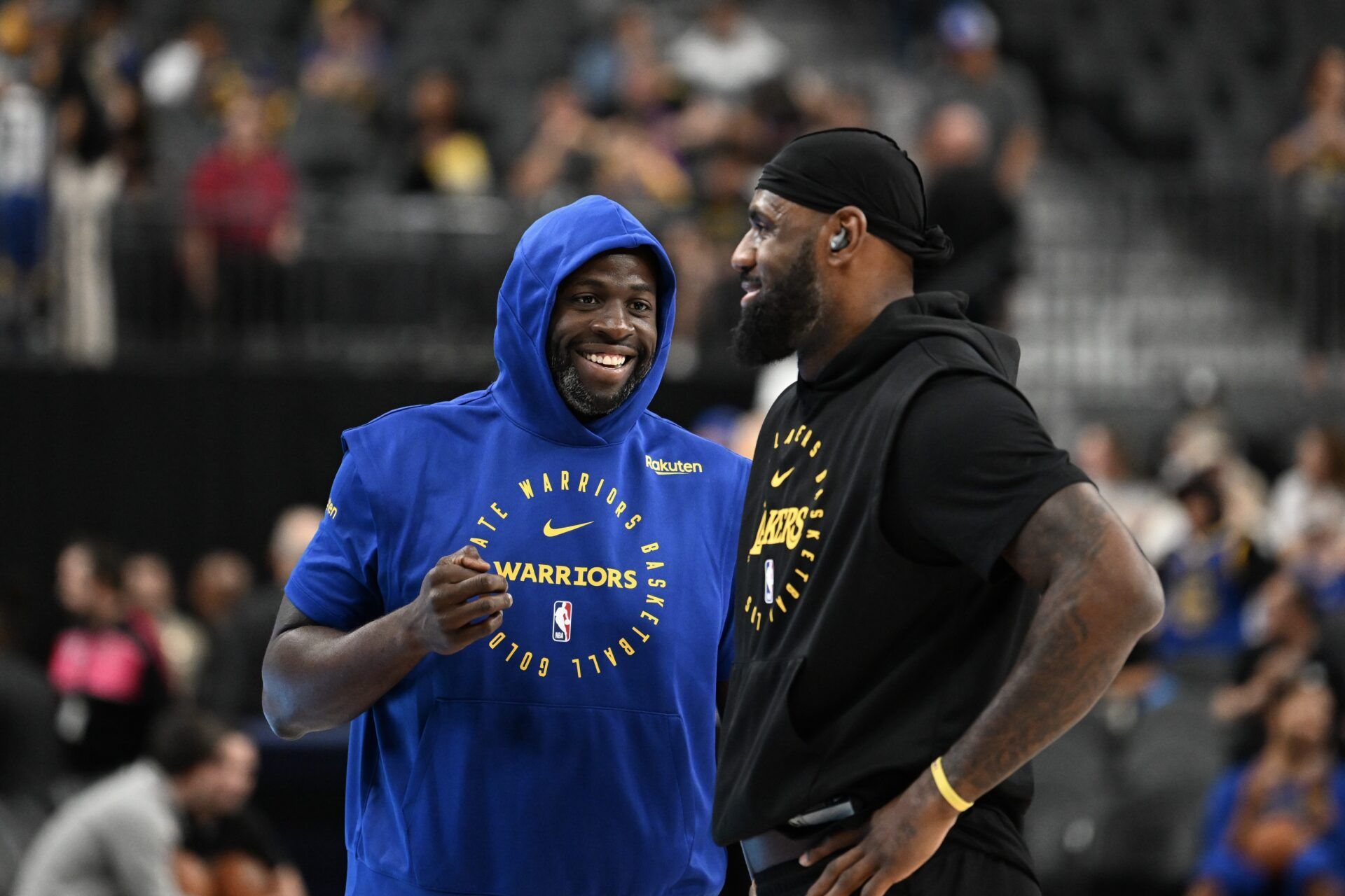 Golden State Warriors forward Draymond Green (23) and Los Angeles Lakers forward LeBron James (23) talk on court before warm up at T-Mobile Arena.