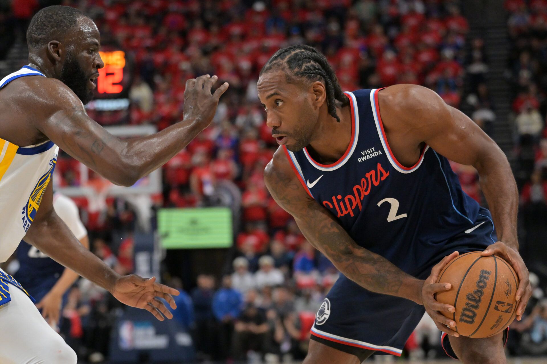 Golden State Warriors forward Draymond Green (23) guards Los Angeles Clippers forward Kawhi Leonard (2) in the first half during the play-in rounds of the 2026 NBA Playoffs at Intuit Dome.