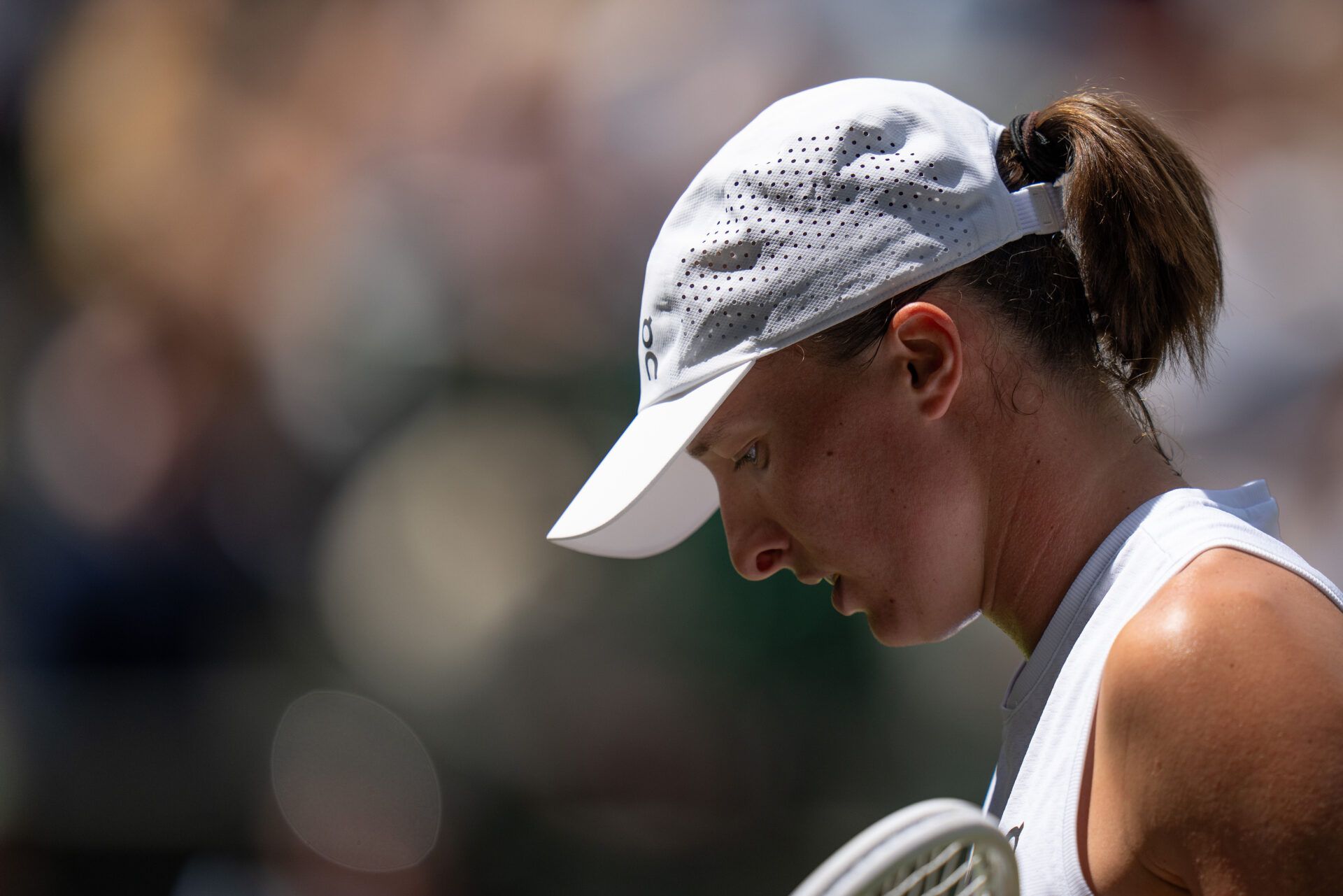 Iga Swiatek of Poland returns a shot during her match against Alexandra Eala of the Philippines on day six at All England Lawn Tennis and Croquet Club.