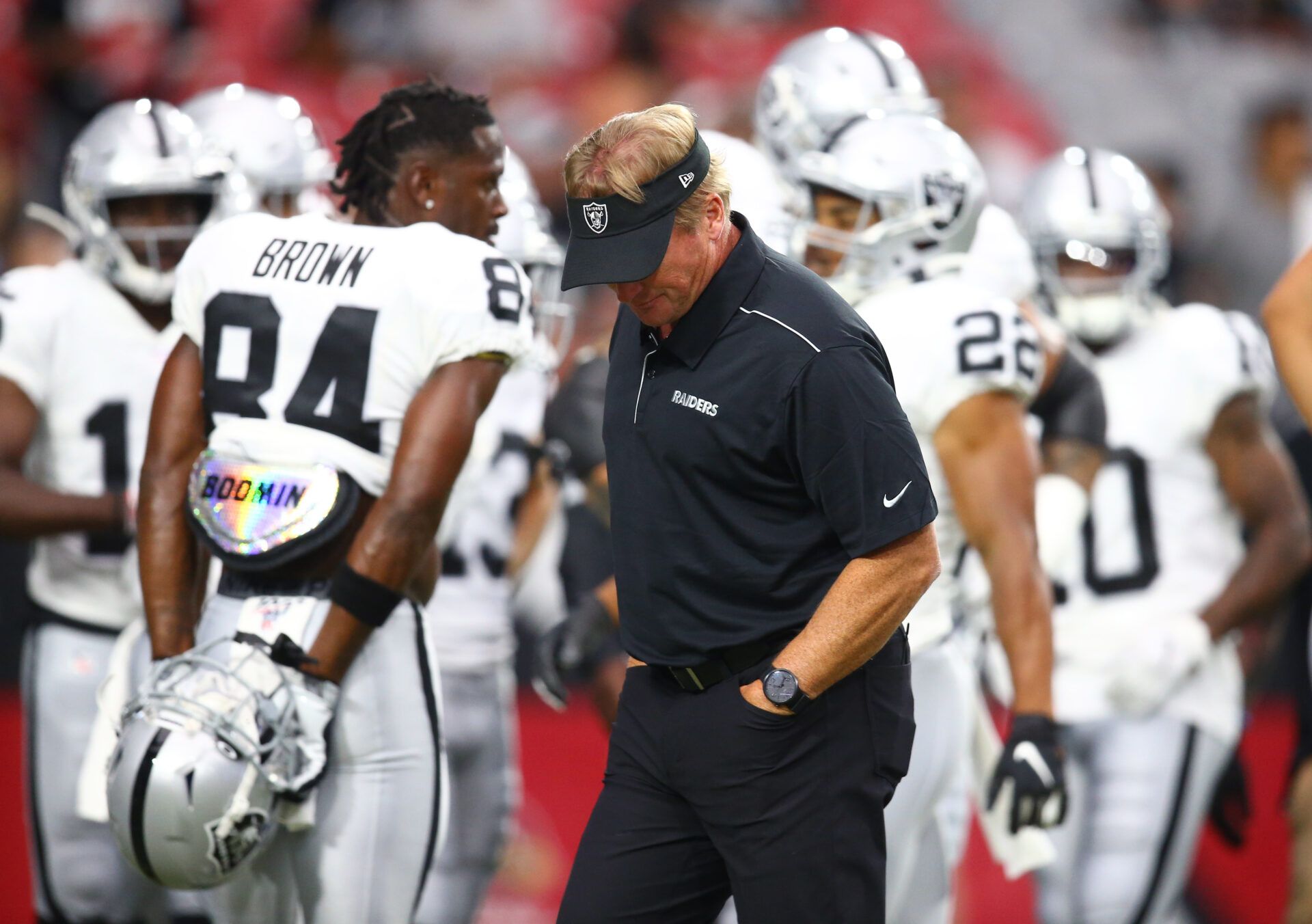 Oakland Raiders head coach Jon Gruden reacts alongside wide receiver Antonio Brown (84) during a preseason game against the Arizona Cardinals at State Farm Stadium.