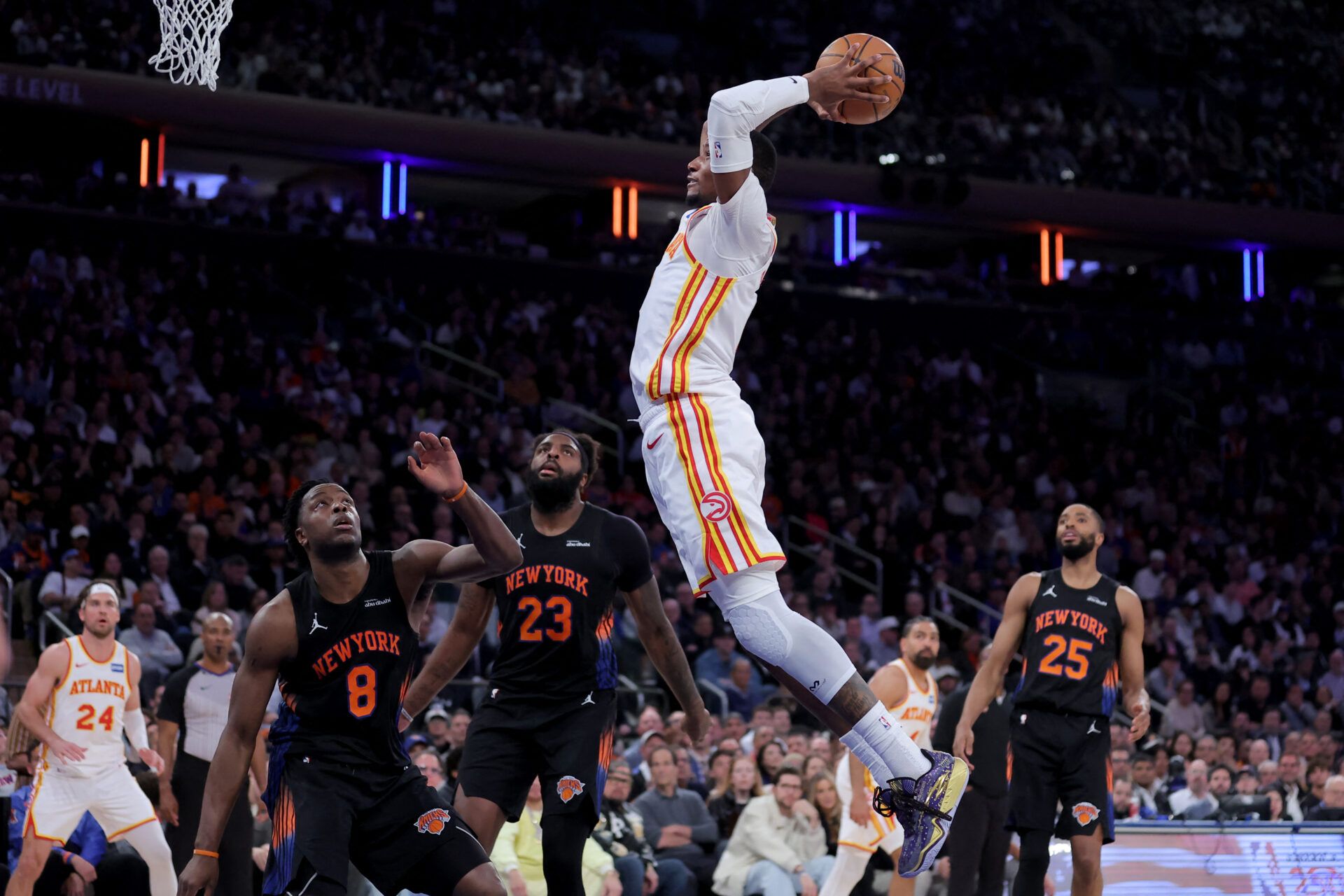 Atlanta Hawks forward Jonathan Kuminga (0) dunks against New York Knicks forward OG Anunoby (8) and center Mitchell Robinson (23) and guard Mikal Bridges (25) during the fourth quarter of game two of the first round of the 2026 NBA Playoffs at Madison Square Garden.
