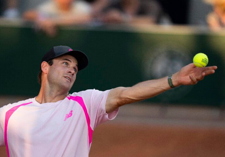Tommy Paul of the United States tosses the ball to serve during his match against Lorenzo Musetti of Italy on day four at Stade Roland Garros.