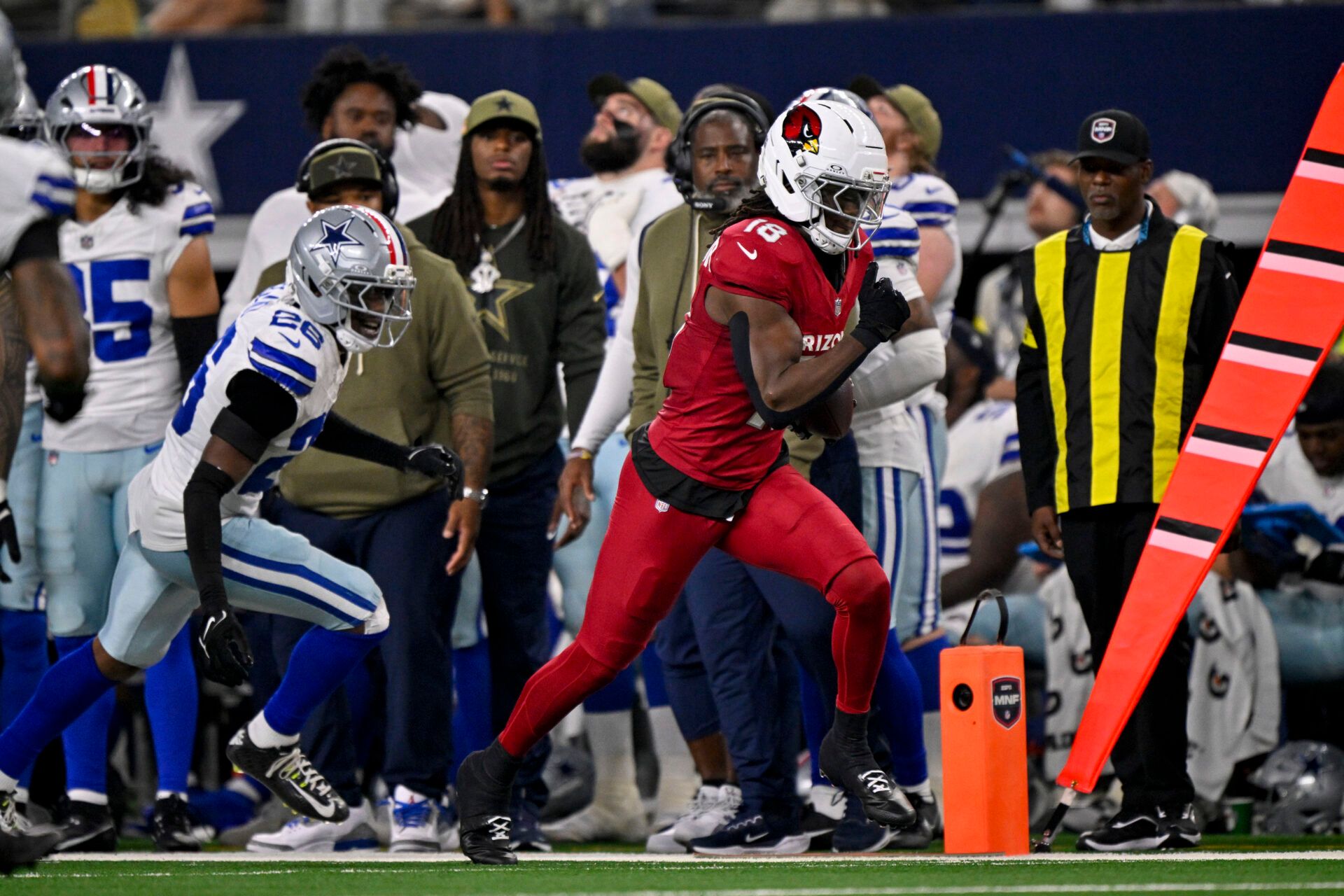 Arizona Cardinals wide receiver Marvin Harrison Jr. (18) runs with the ball past Dallas Cowboys cornerback DaRon Bland (26) during the game between the Dallas Cowboys and the Arizona Cardinals at AT&T Stadium.