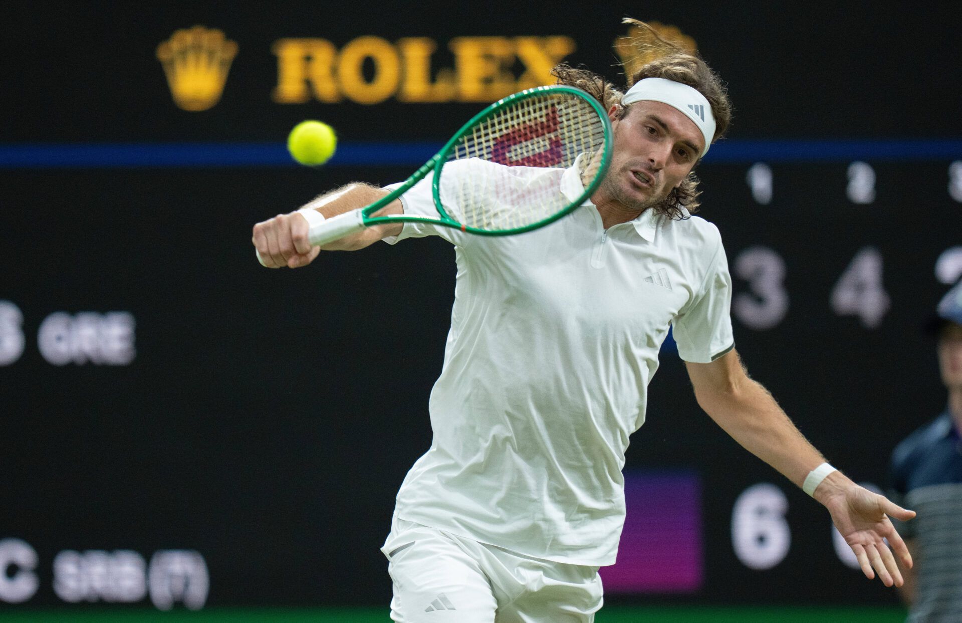 Stefanos Tsitsipas of Greece returns a shot during his match against Novak Djokovic of Serbia on day three at All England Lawn Tennis and Croquet Club.