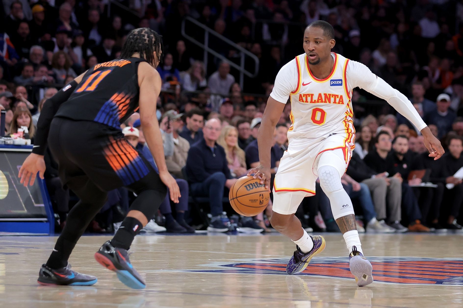 Atlanta Hawks forward Jonathan Kuminga (0) controls the ball against New York Knicks guard Jalen Brunson (11) during the fourth quarter of game two of the first round of the 2026 NBA Playoffs at Madison Square Garden.