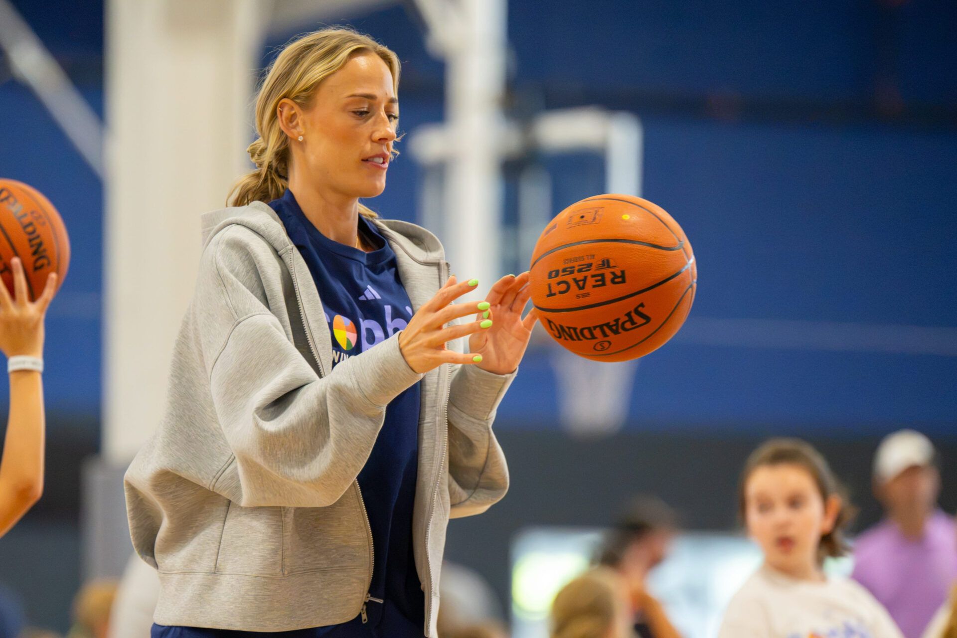 Indiana Fever guard Sophie Cunningham interacts with young basketball players during a youth basketball camp for students in grades 1-8 at Aletto Family Sports Center in Carmel, Indiana, on Sunday, July 19, 2026. The camp gave participants the opportunity to develop their basketball skills through drills, instruction and games while learning from one of the WNBAs most popular players.