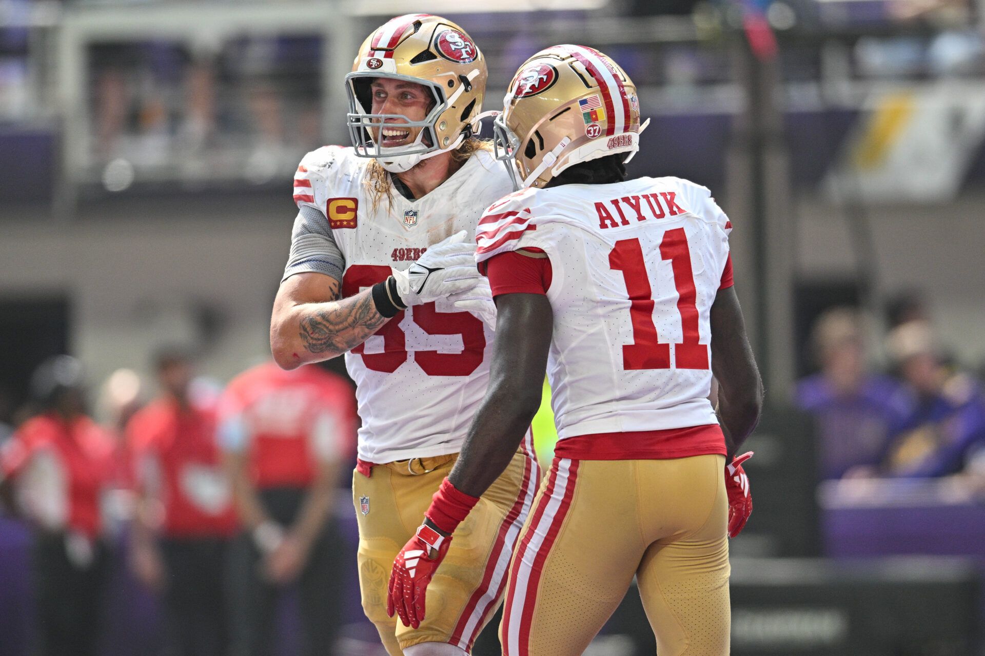 San Francisco 49ers tight end George Kittle (85) and wide receiver Brandon Aiyuk (11) react after a touchdown by Kittle during the second quarter against the Minnesota Vikings U.S. Bank Stadium.