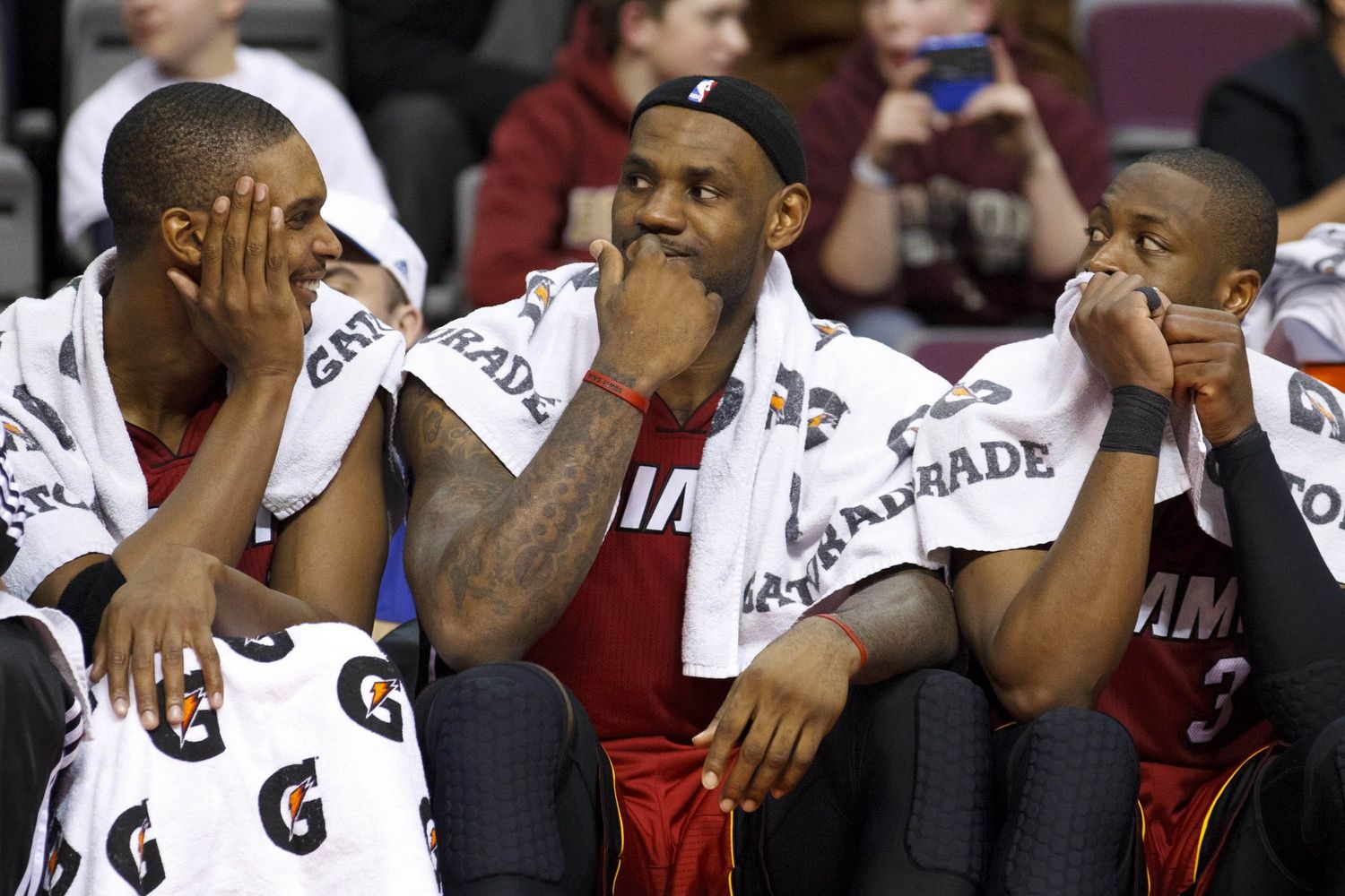 Miami Heat power forward Chris Bosh (left), small forward LeBron James (center), and shooting guard Dwyane Wade (3) sit on the bench in the fourth quarter of an NBA game at The Palace. Miami defeated Detroit 106-92.
