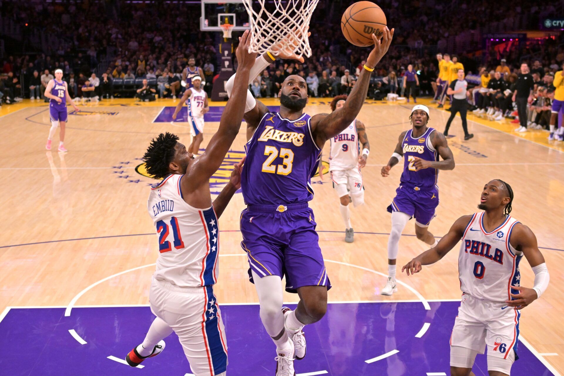 Los Angeles Lakers forward LeBron James (23) drives past Philadelphia 76ers center Joel Embiid (21) in the second half at Crypto.com Arena.