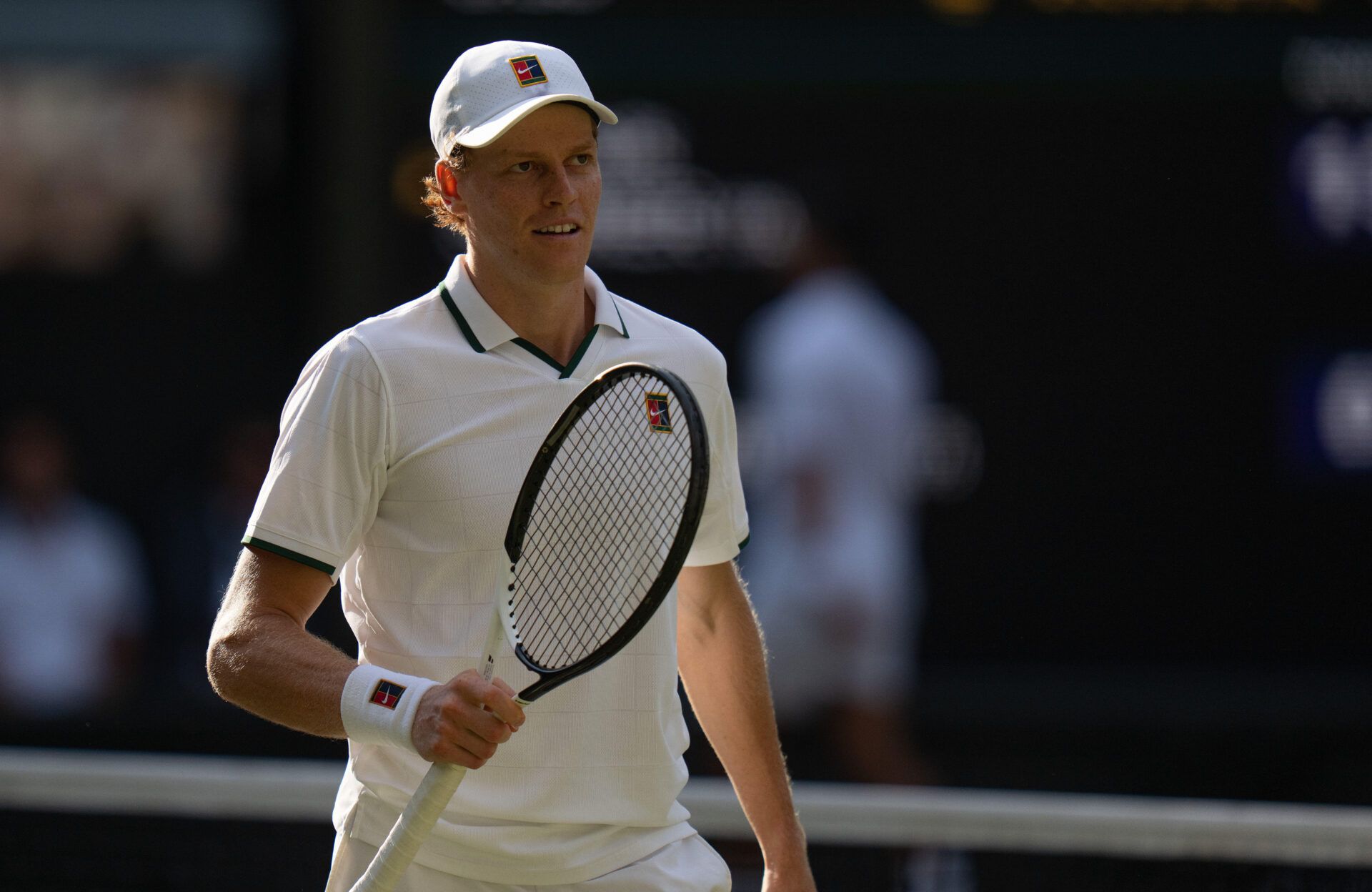 Jannik Sinner of Italy reacts during his semifinal match against Novak Djokovic of Serbia on day 12 at All England Lawn Tennis and Croquet Club.
