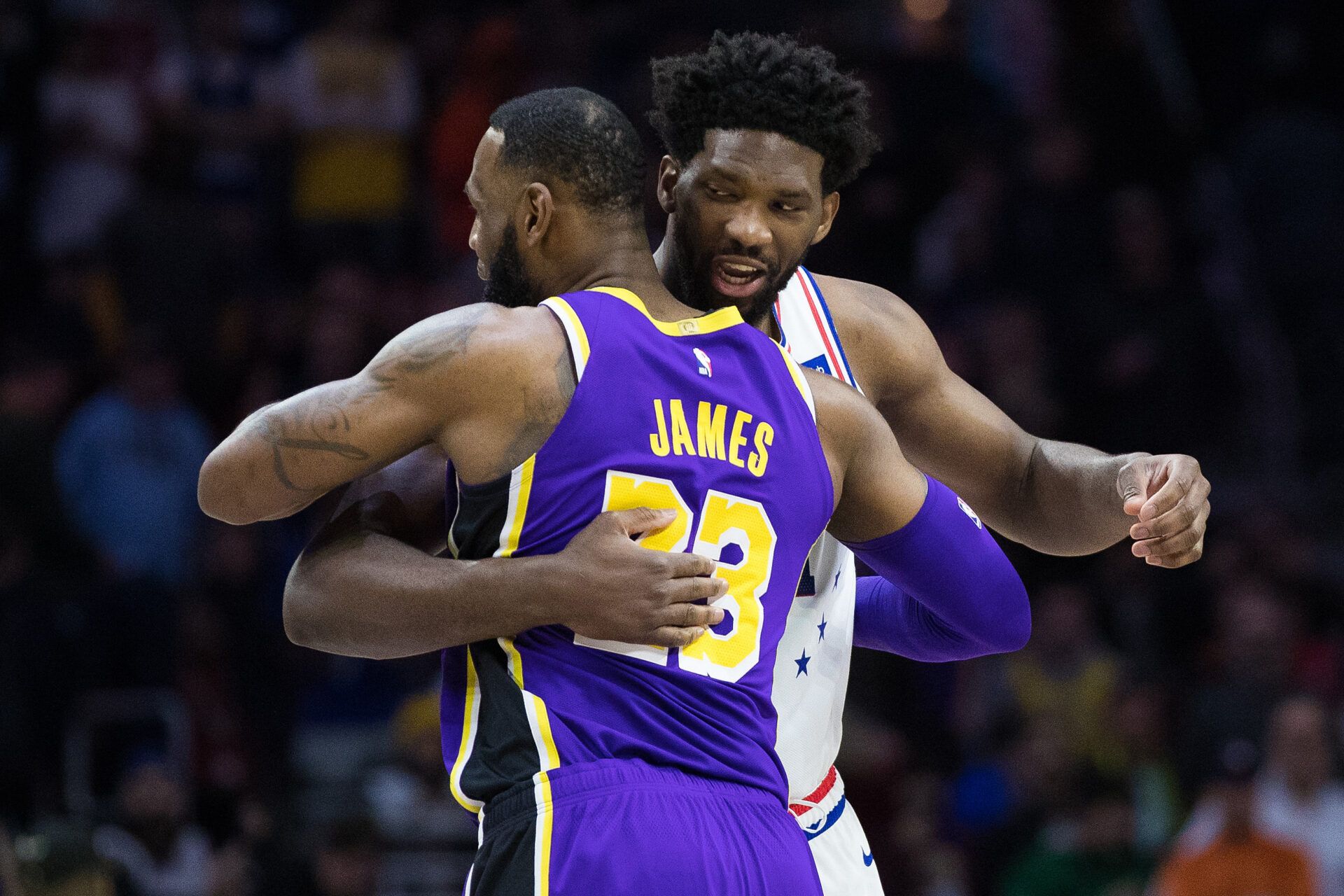 Los Angeles Lakers forward LeBron James (23) and Philadelphia 76ers center Joel Embiid (21) embrace before the first quarter at Wells Fargo Center.