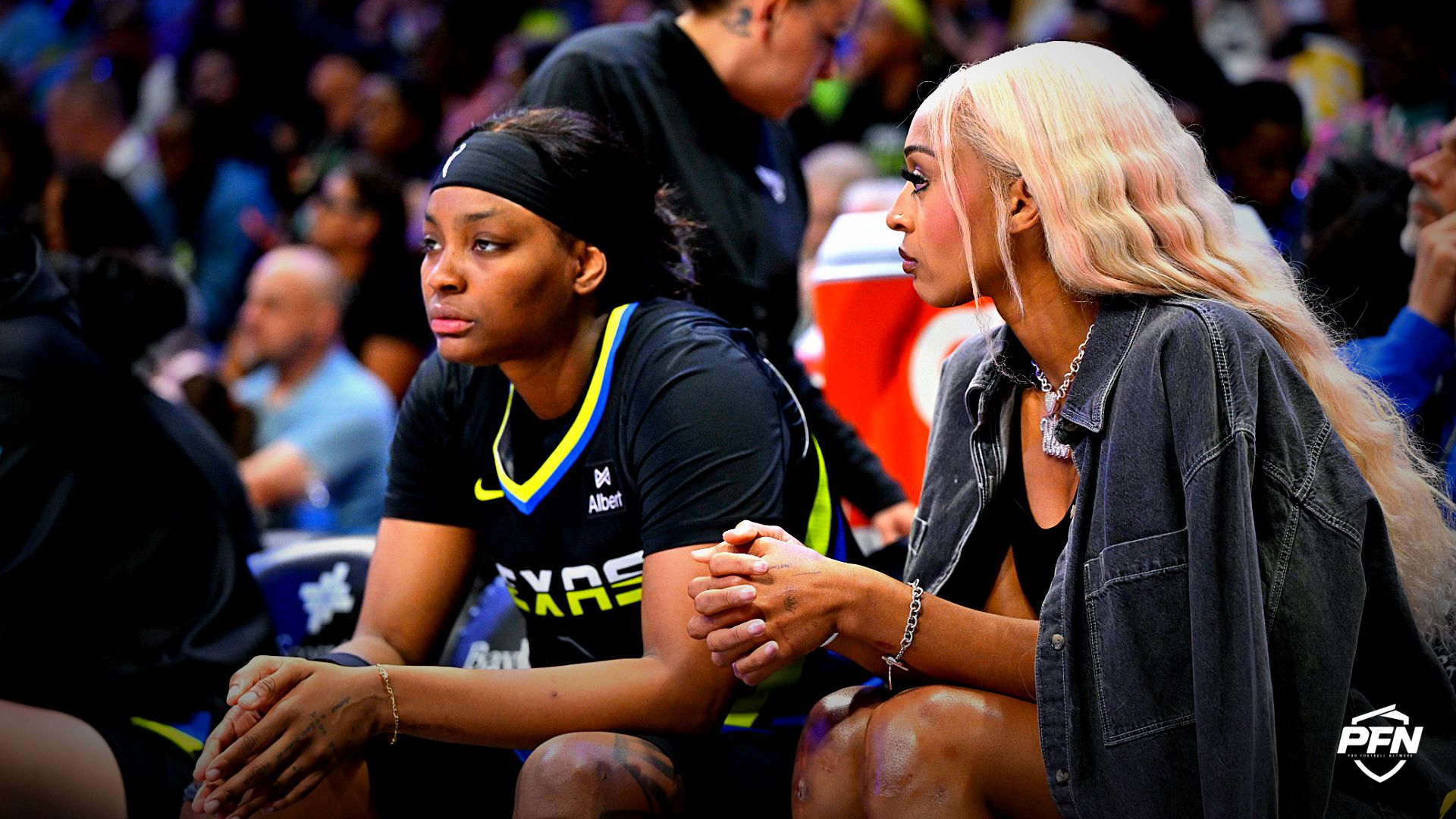 Dallas Wings forward NaLyssa Smith (1) and guard DiJonai Carrington (21) look on from the team bench during the first half against the Washington Mystics at College Park Center.