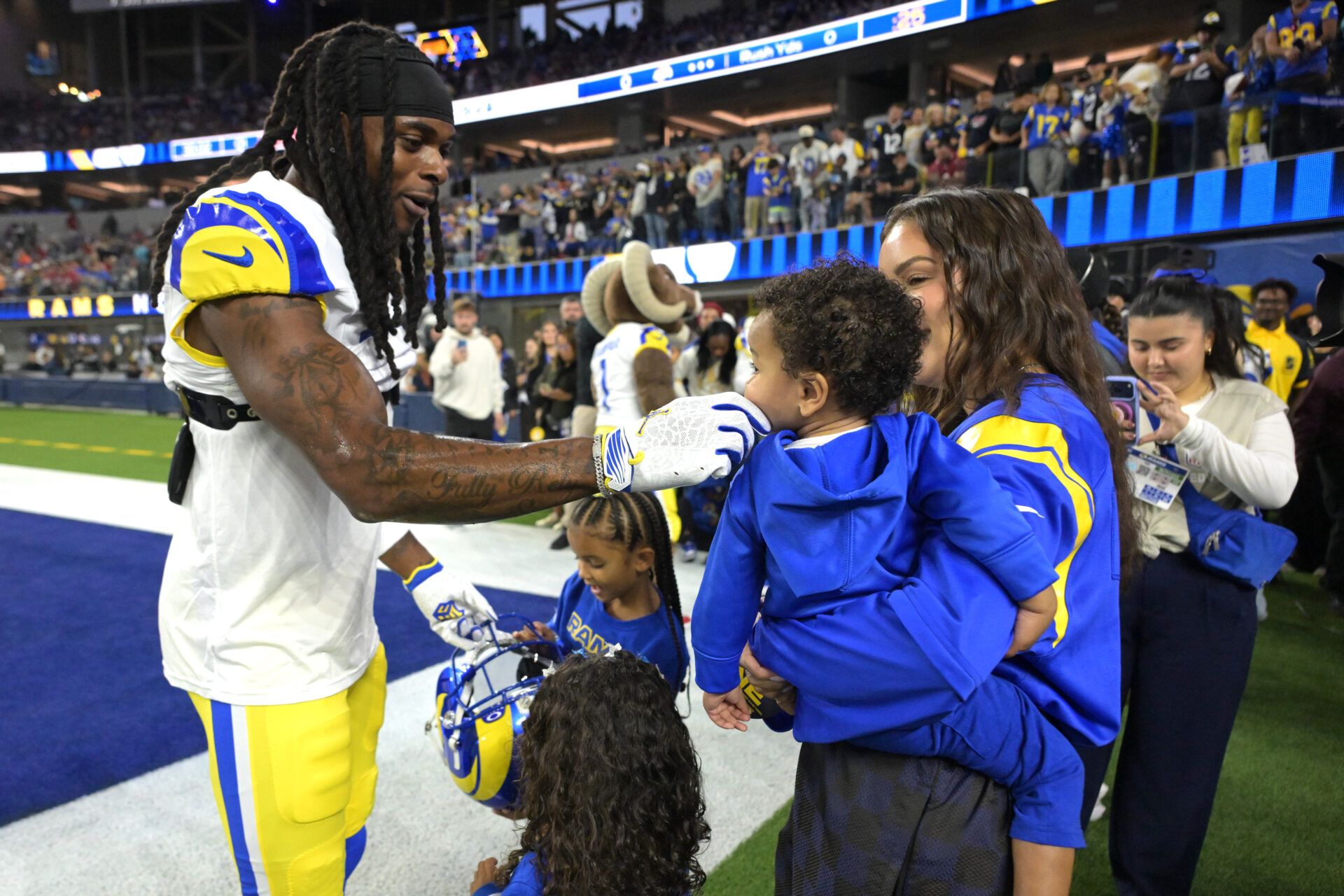 Los Angeles Rams wide receiver Davante Adams (17) with his family on the field prior to the game against the Tampa Bay Buccaneers at SoFi Stadium.