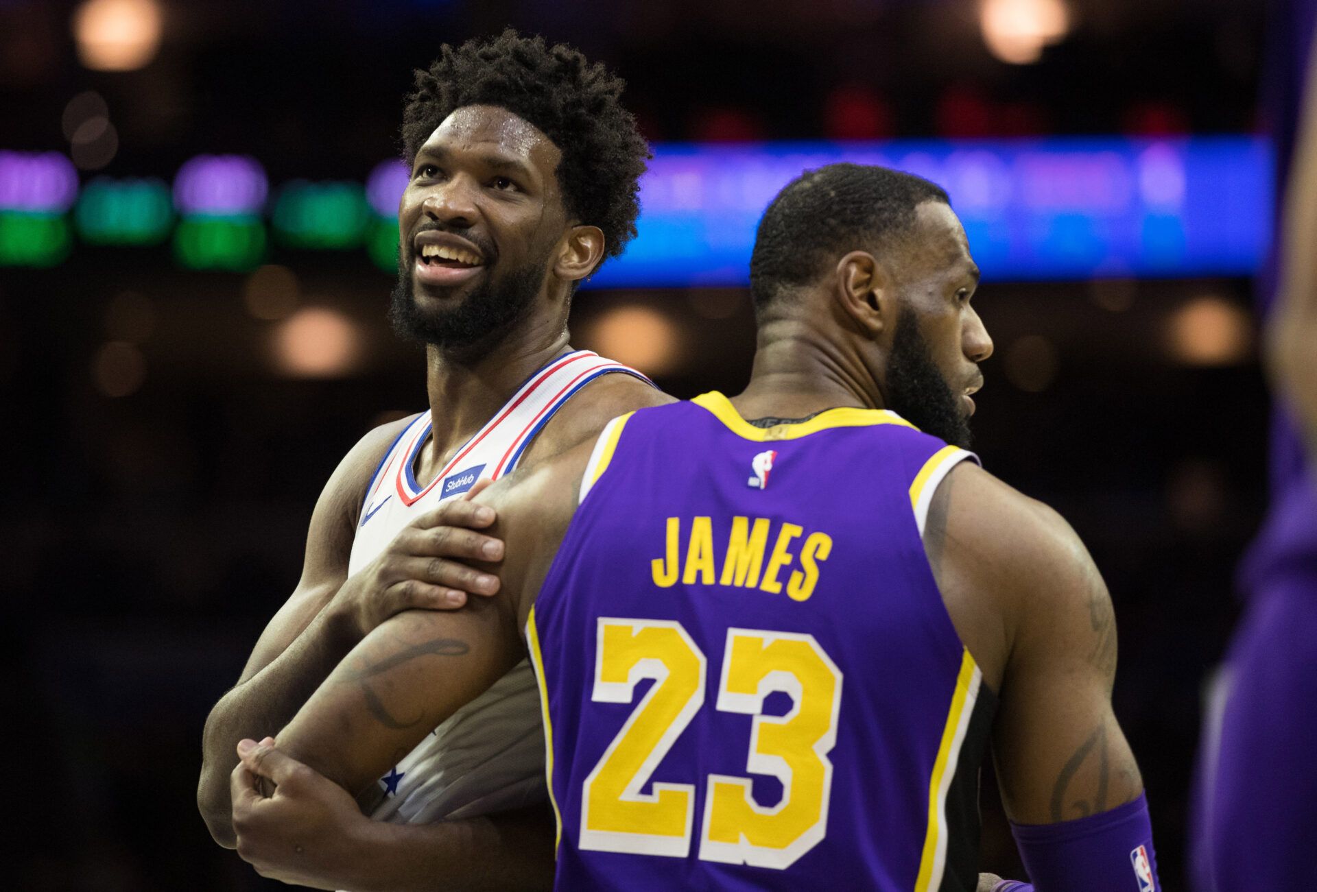 Philadelphia 76ers center Joel Embiid (21) reacts with Los Angeles Lakers forward LeBron James (23) after a 76ers score during the fourth quarter at Wells Fargo Center.